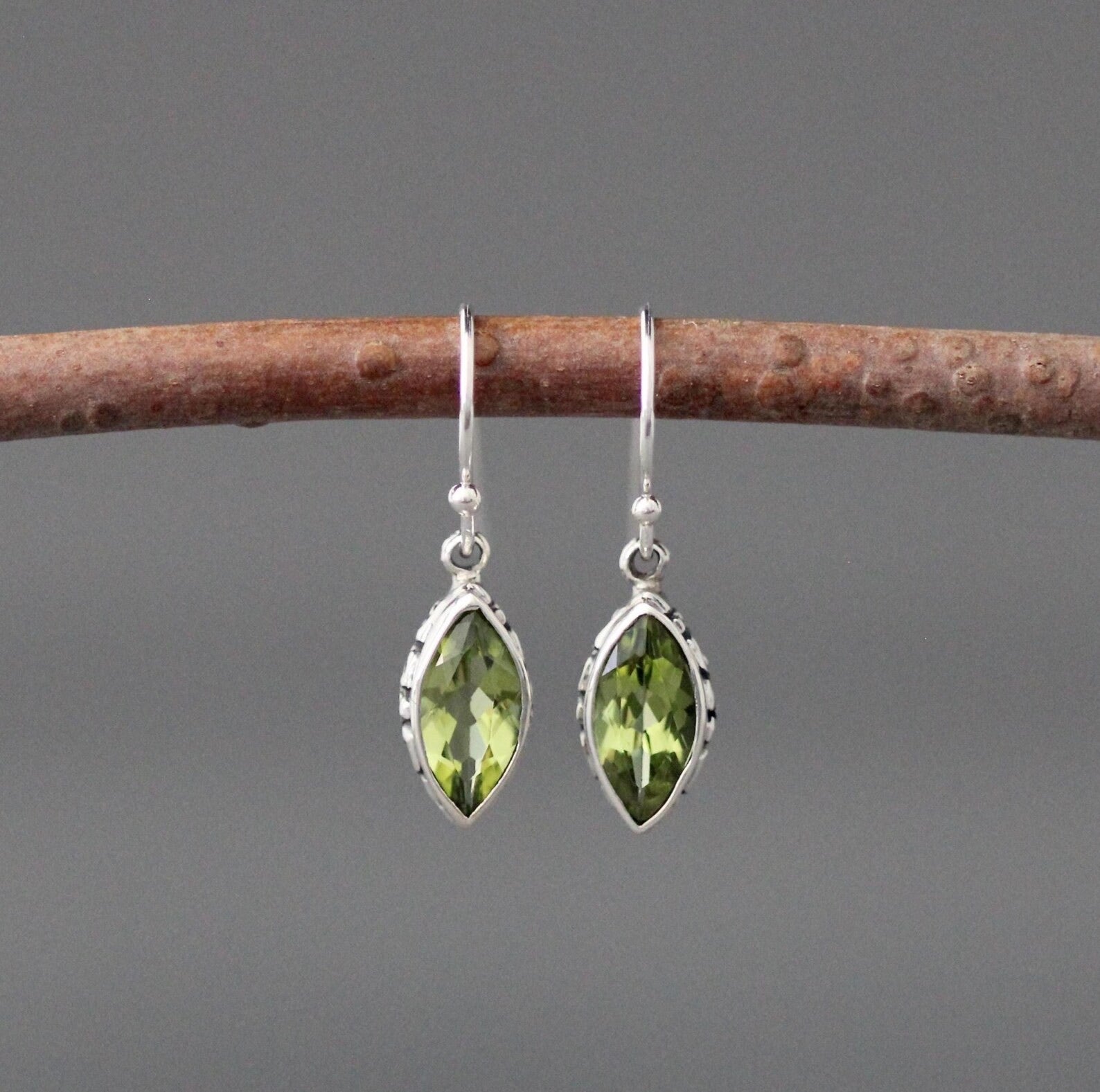 Silver drop earrings with marquise green peridot stones and dangle hooks