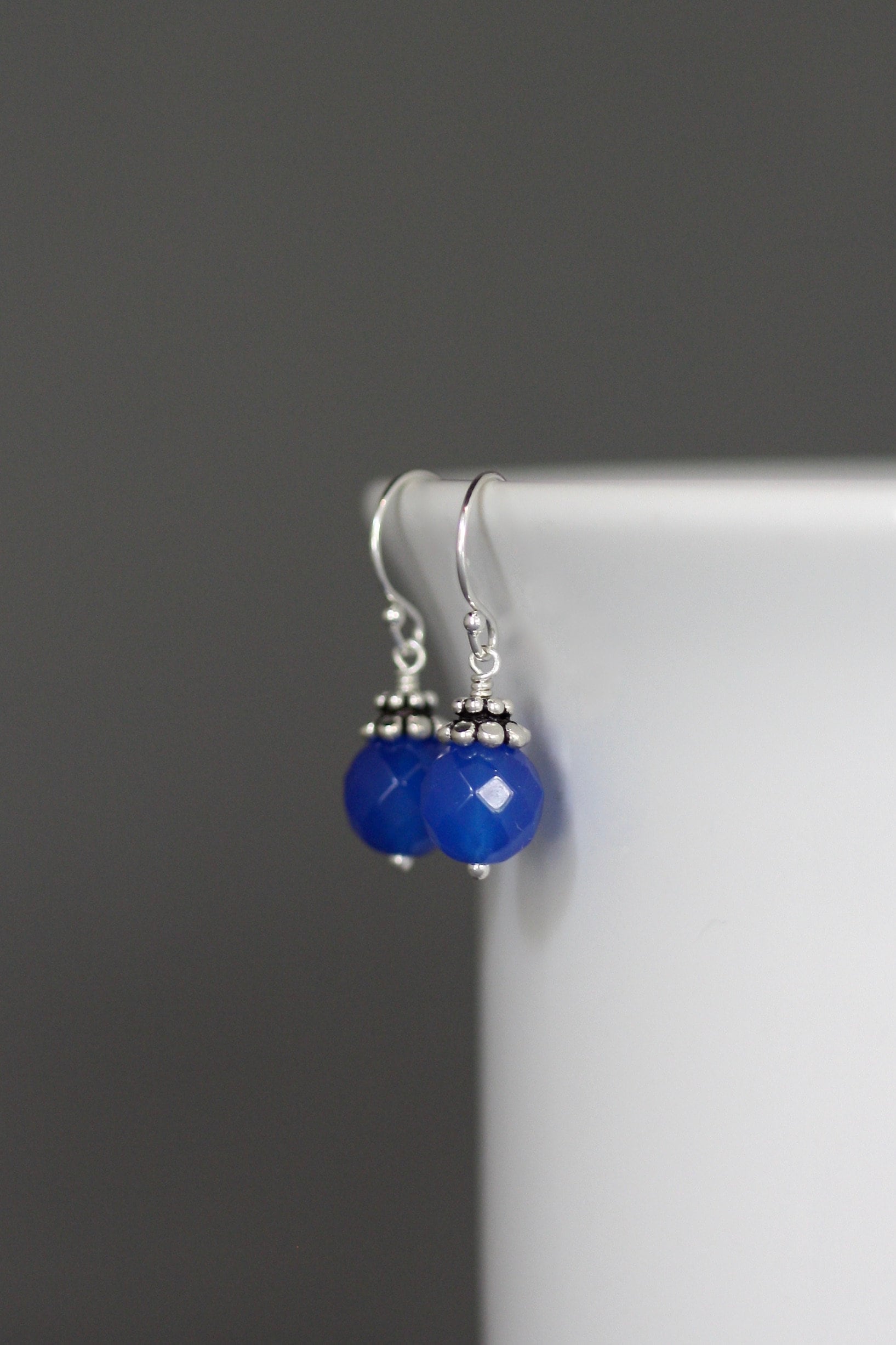 Blue agate bead earrings with silver Bali-style caps and dangling hooks