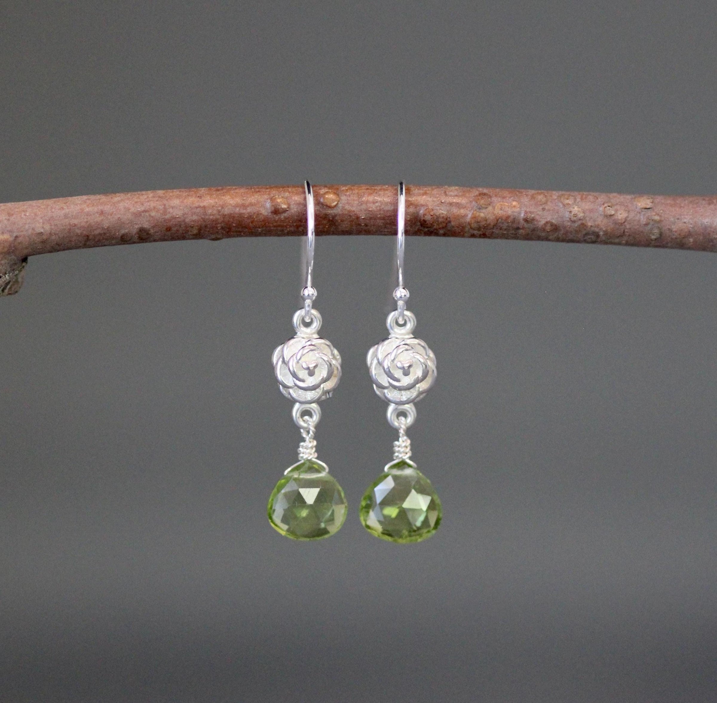 Sterling silver drop earrings with green peridot teardrop beads on flower links