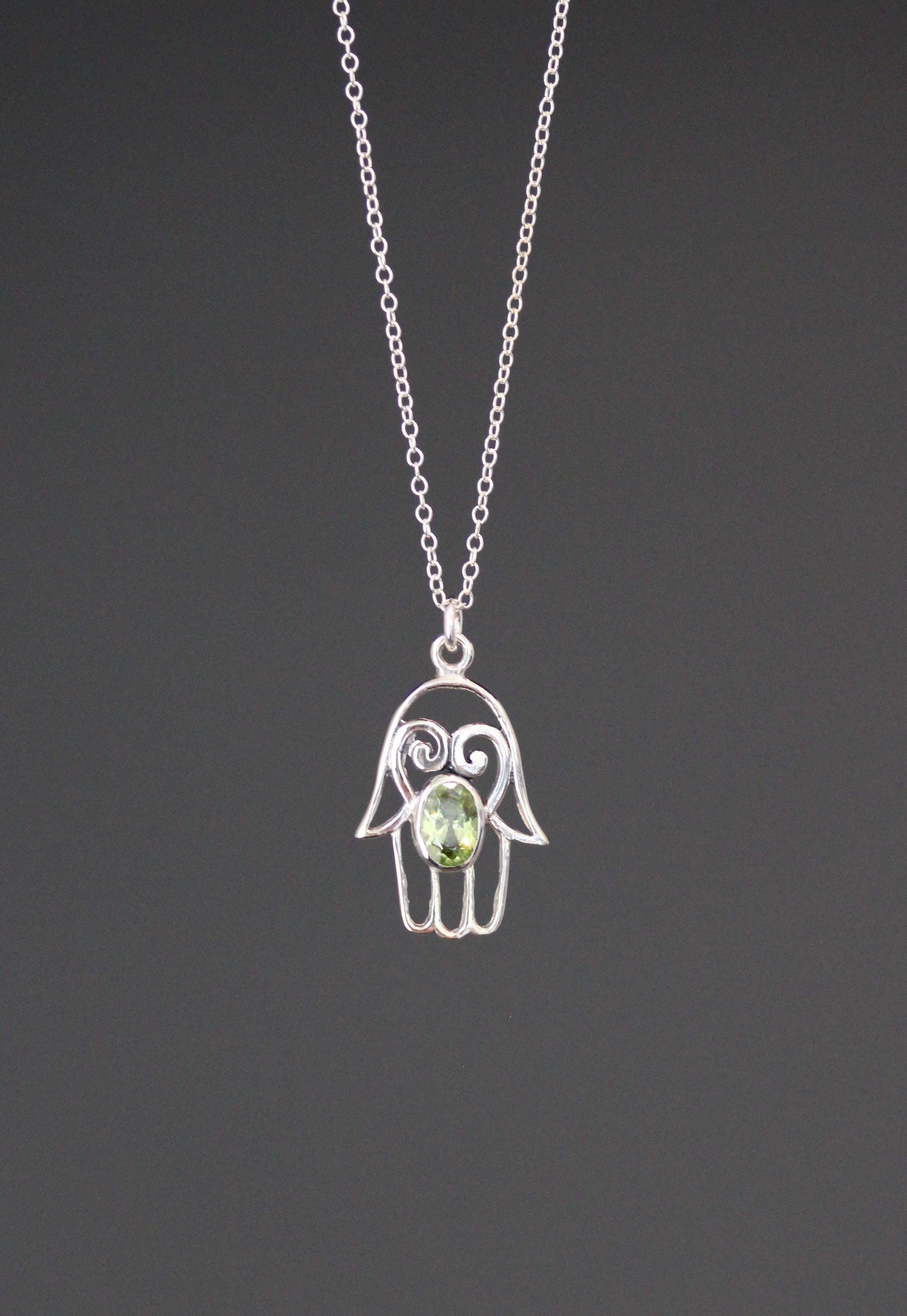 Sterling silver hamsa pendant necklace with round green peridot-style stone on fine chain