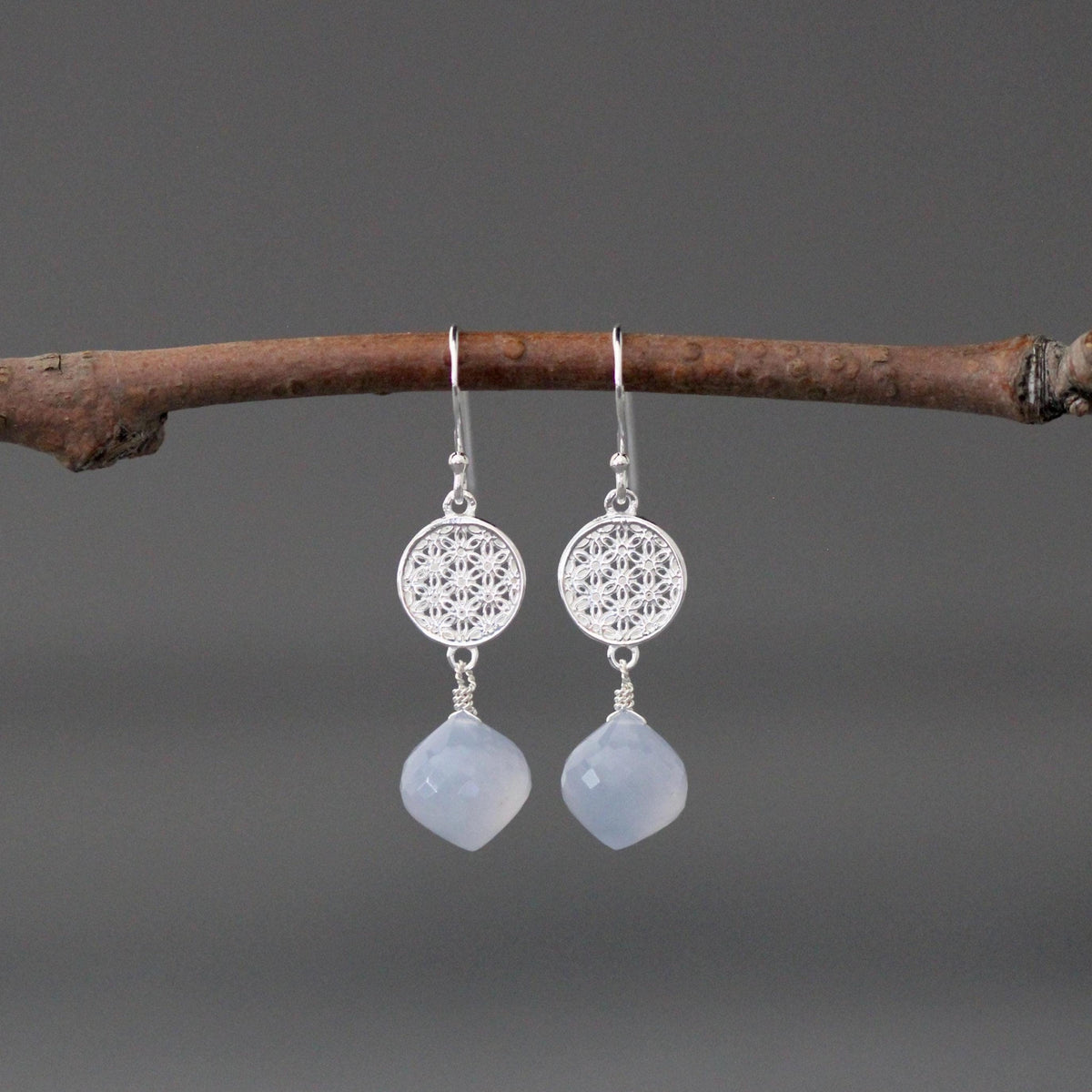 Sterling silver drop earrings with round filigree caps and blue chalcedony teardrops