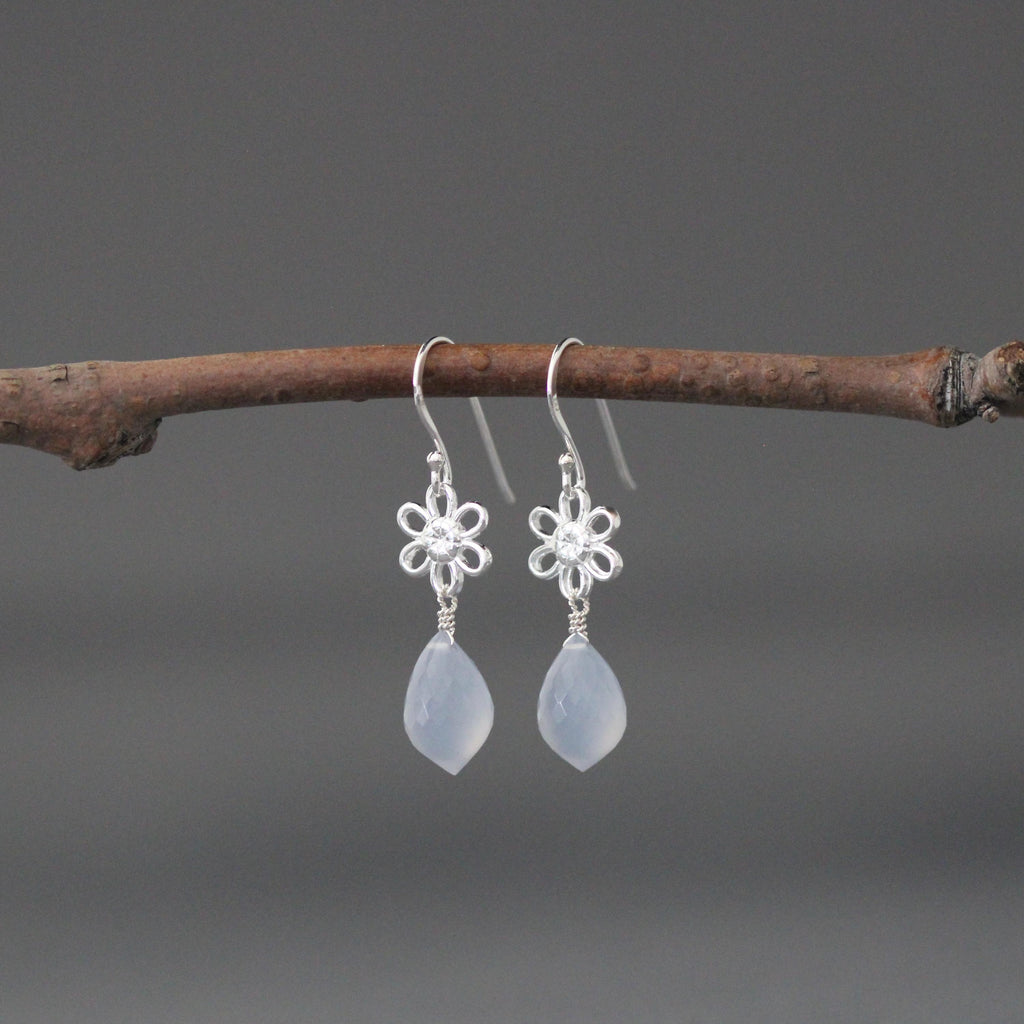 Pair of sterling silver flower dangle earrings with blue teardrop stones
