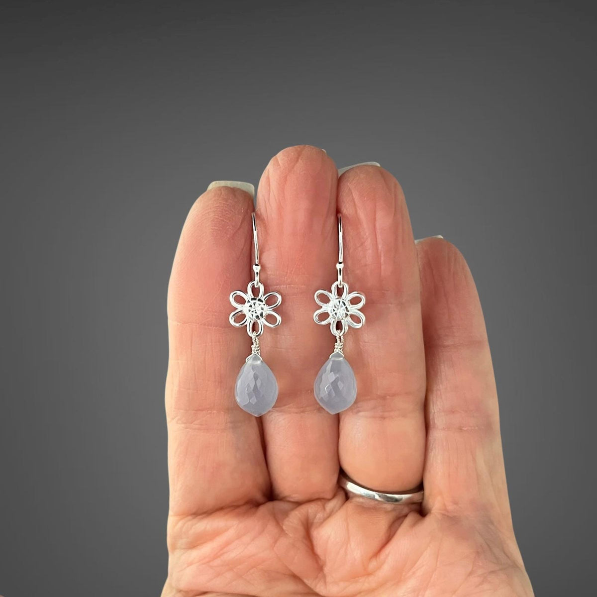 Sterling silver blue teardrop dangle earrings with etched flower hooks