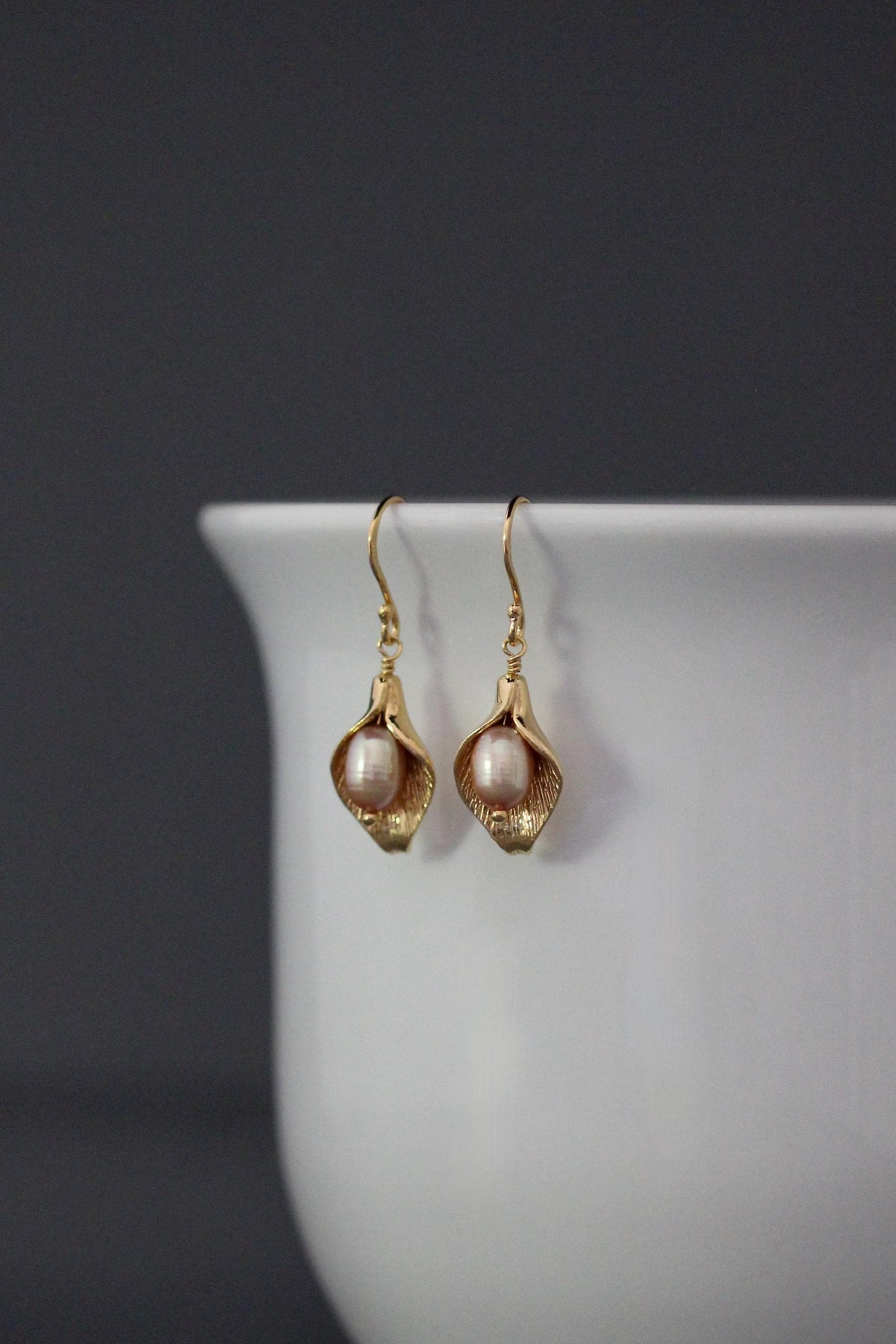 Peach freshwater pearl calla lily dangle earrings with gold-toned earwires
