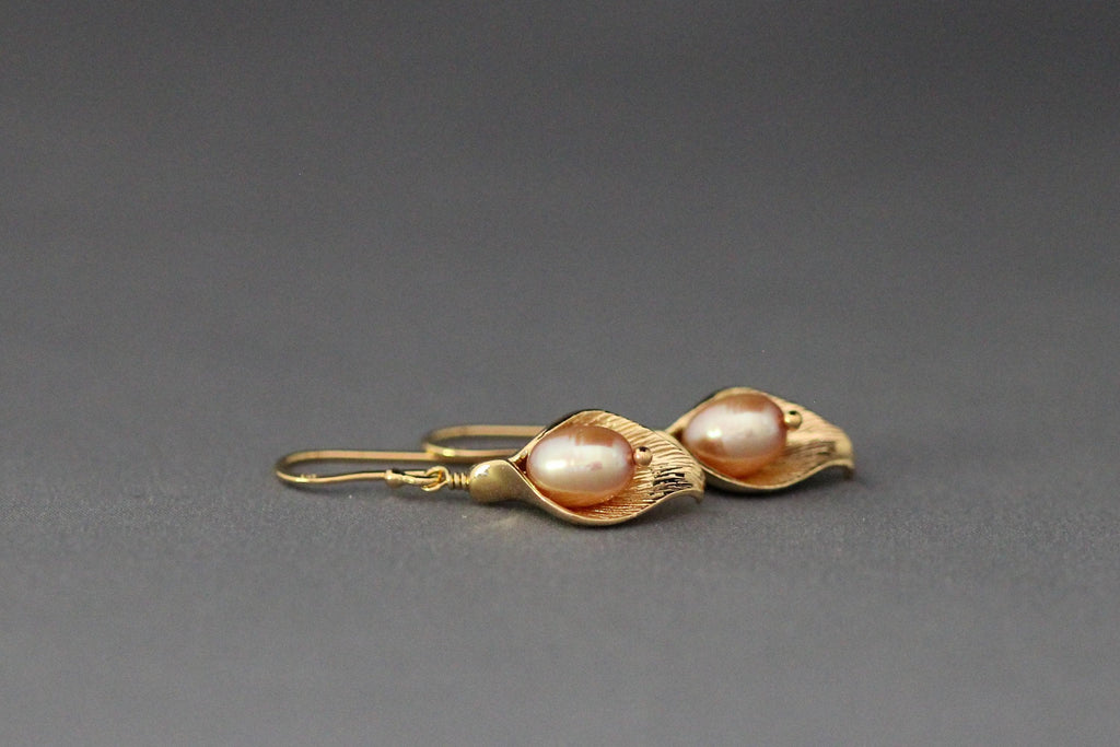 Gold-tone calla lily charm earrings with peach freshwater pearl drops
