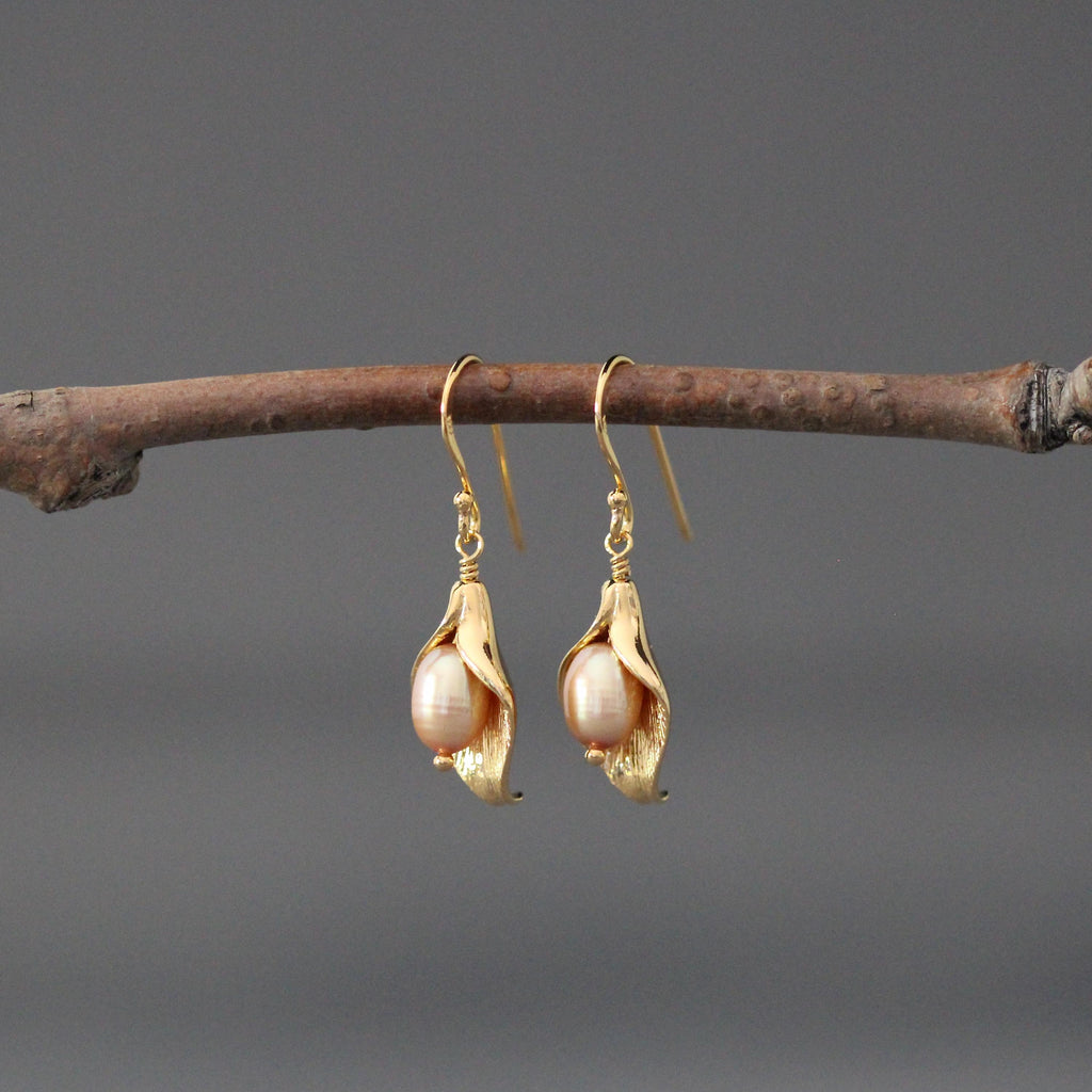 Peach freshwater pearl calla lily dangle earrings on gold-toned earwires