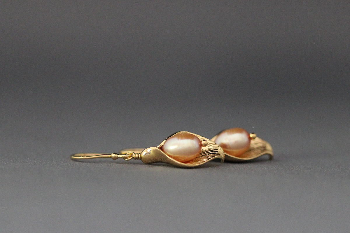 Peach freshwater pearl calla lily charm earrings with gold-toned finish