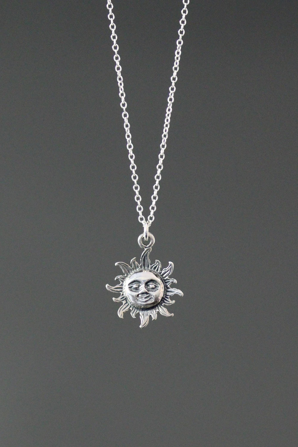 Sterling silver sun pendant necklace with small radiant sun charm on chain