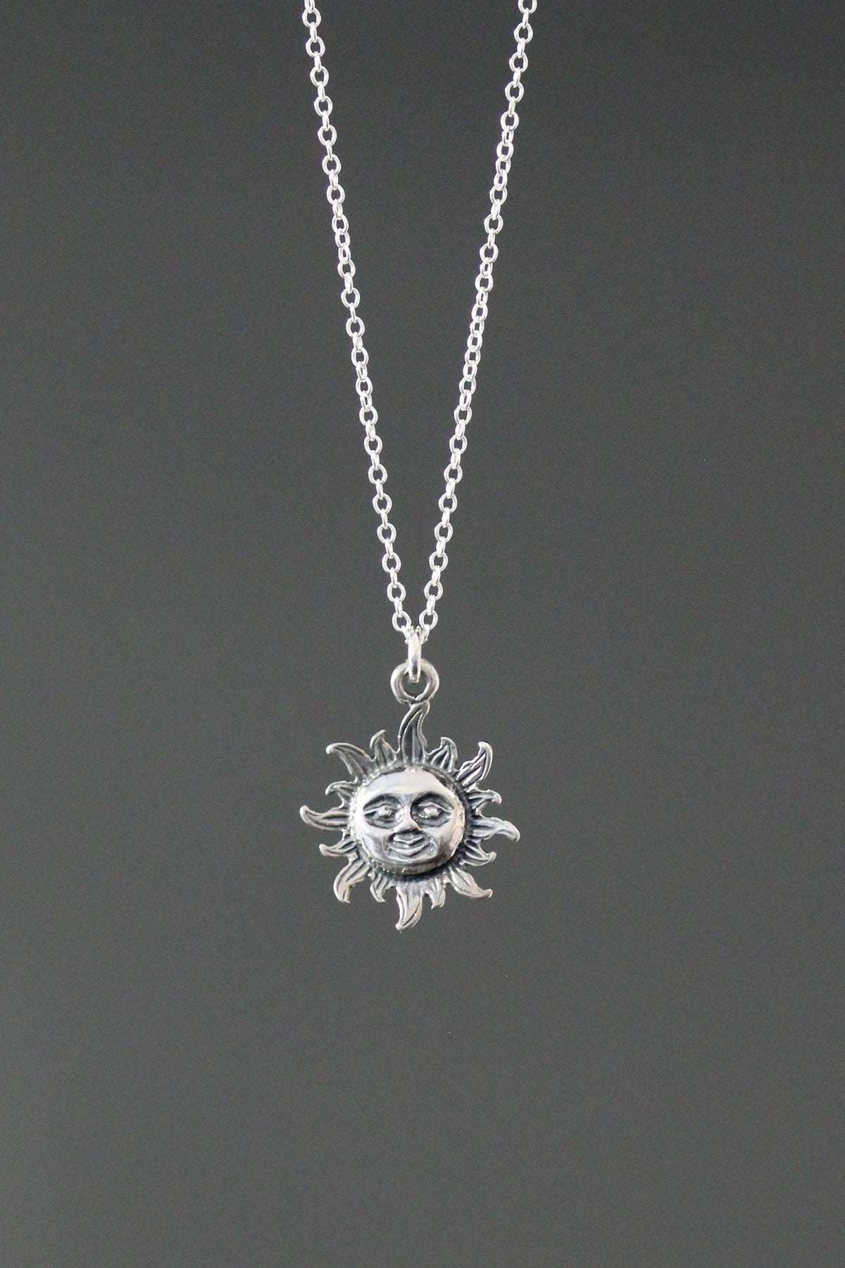 Sterling silver sun pendant necklace with small radiant sun charm on chain