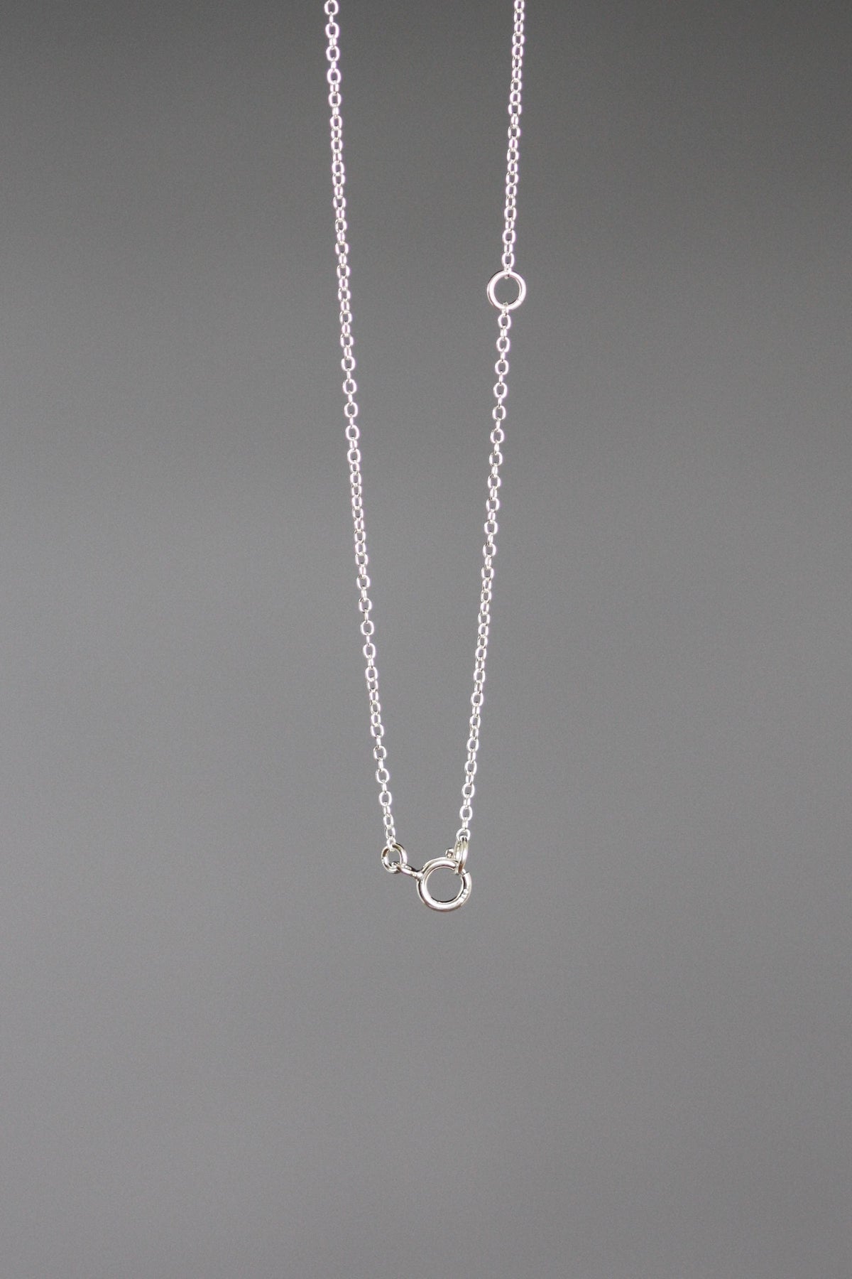 Sterling silver chain necklace with small sun pendant and round clasp detail