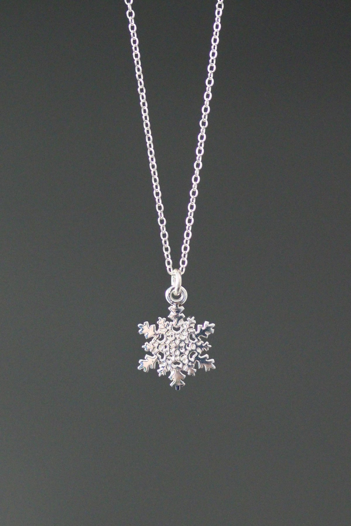 Sterling silver snowflake charm necklace with pendant on cable chain