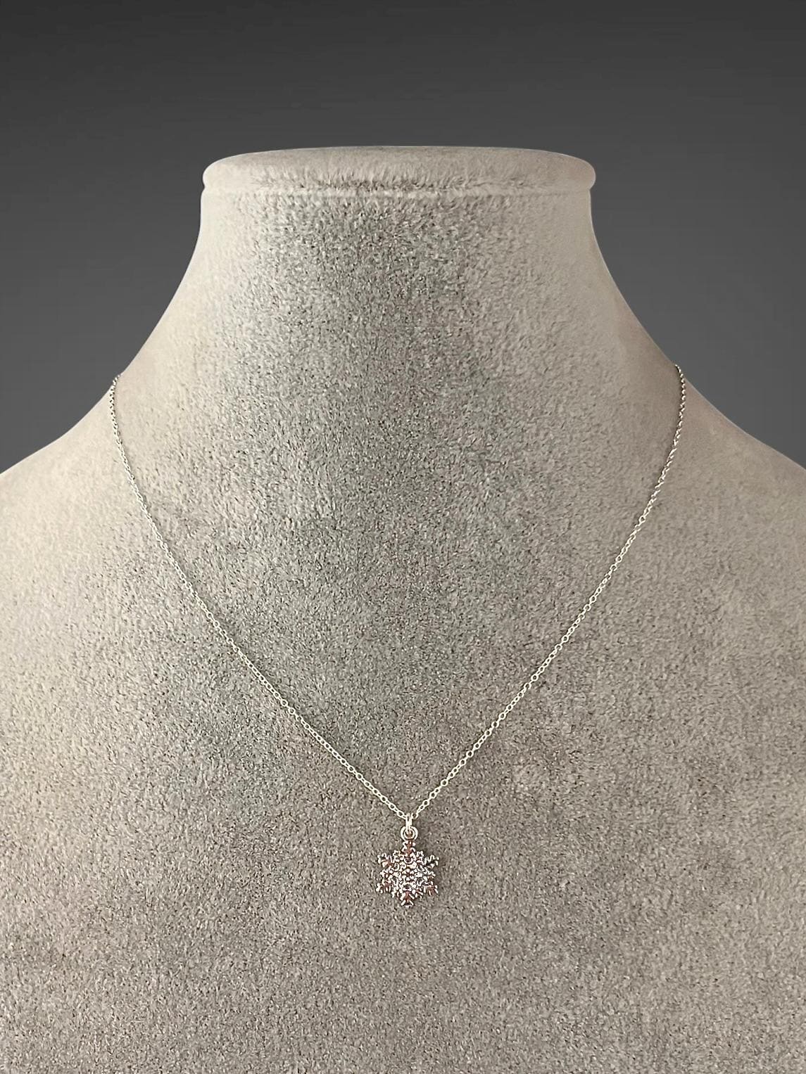 Sterling silver snowflake charm necklace with centered snowflake pendant on chain