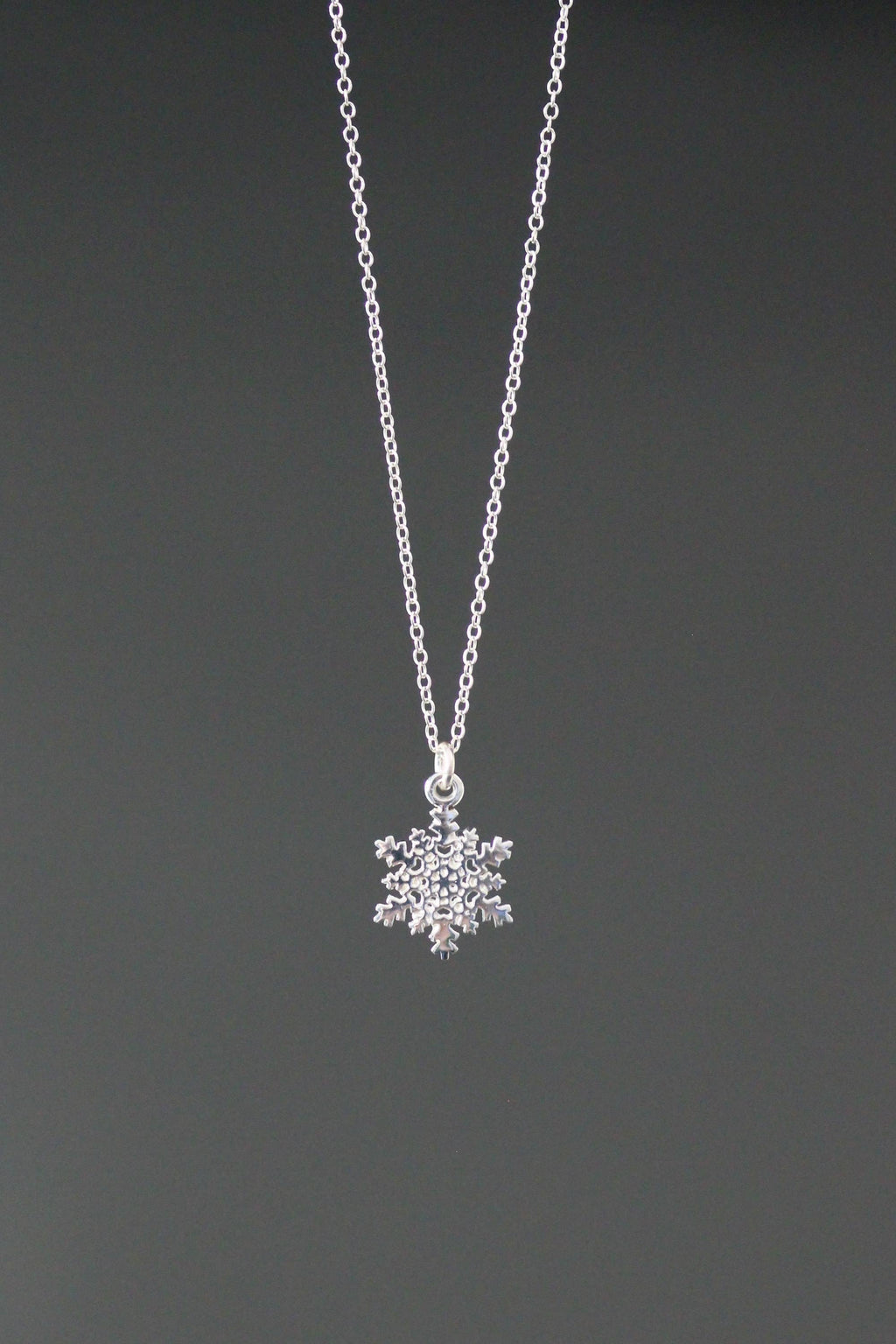 Sterling silver snowflake charm necklace with detailed snowflake pendant