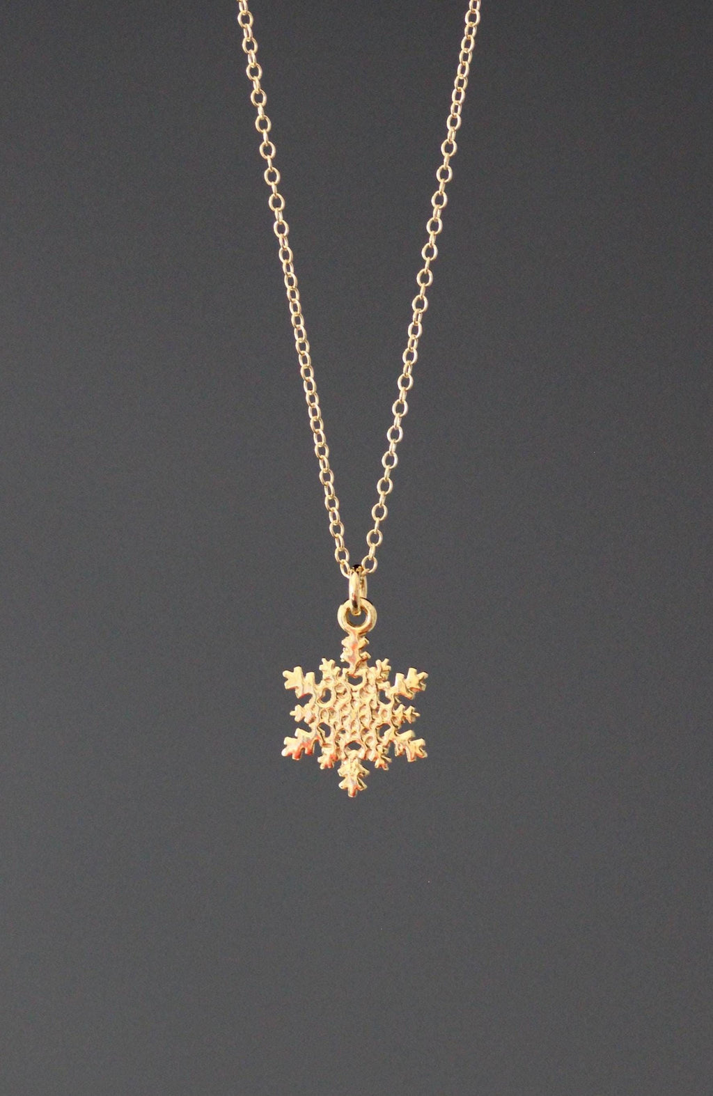 Gold vermeil snowflake charm necklace on a fine chain