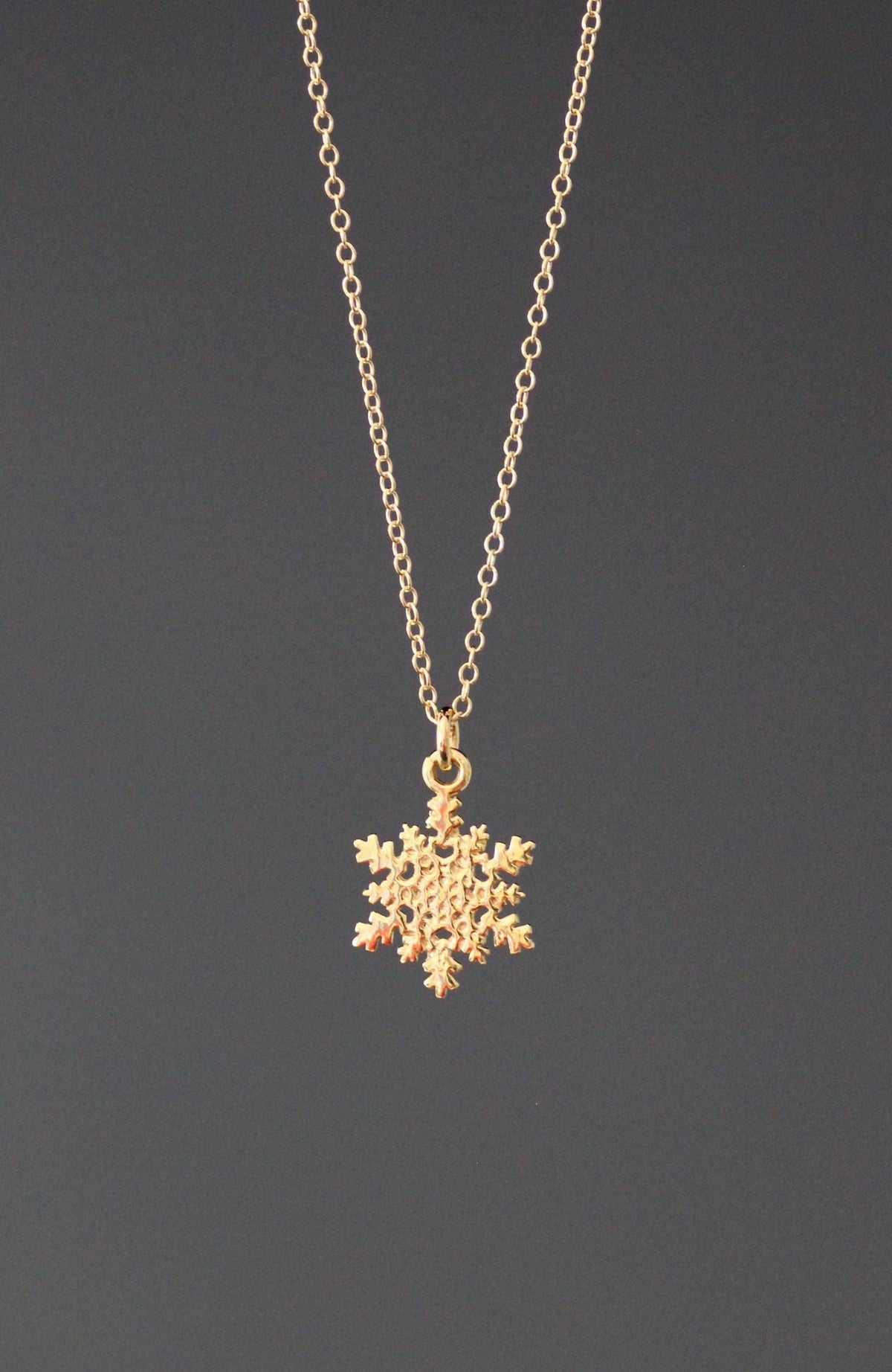 Gold vermeil snowflake charm necklace on a fine chain