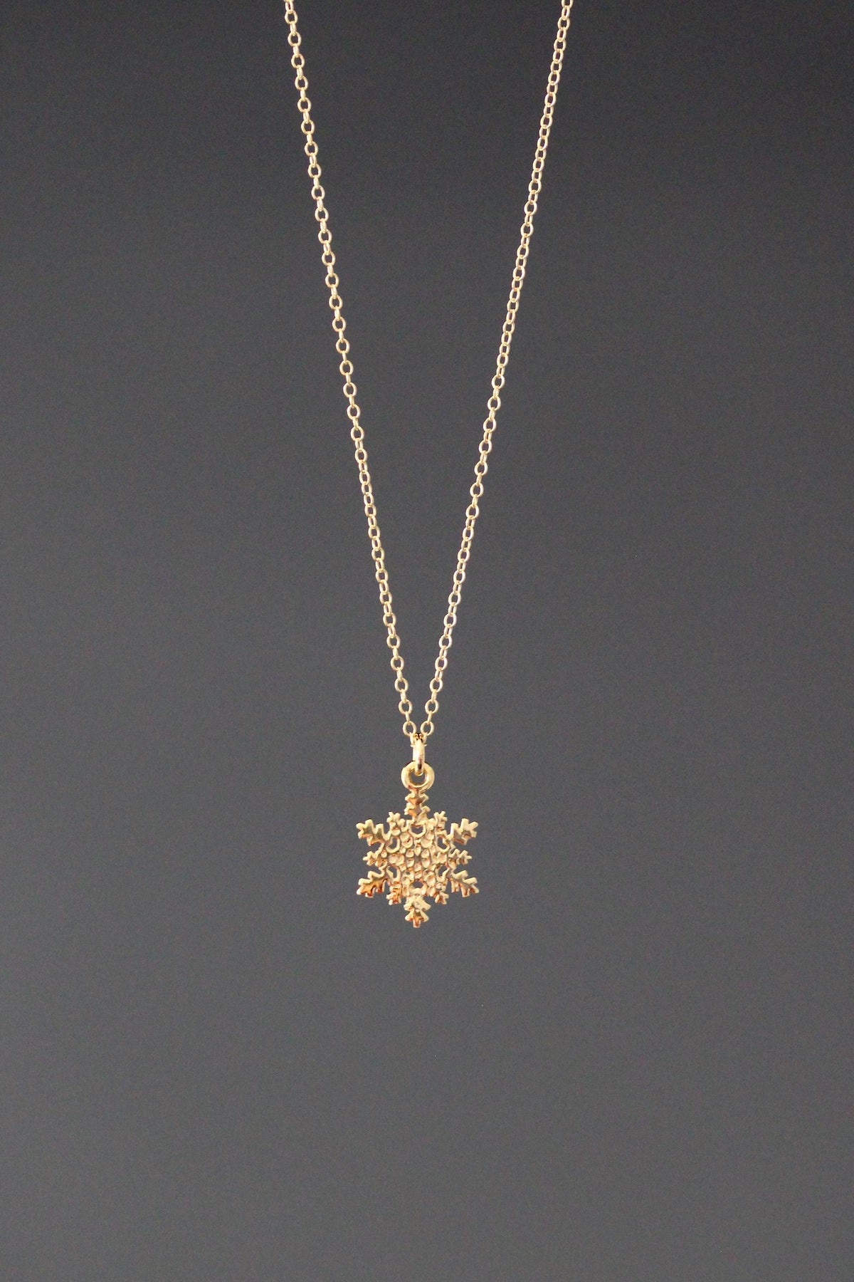 Gold vermeil snowflake charm necklace with a delicate chain