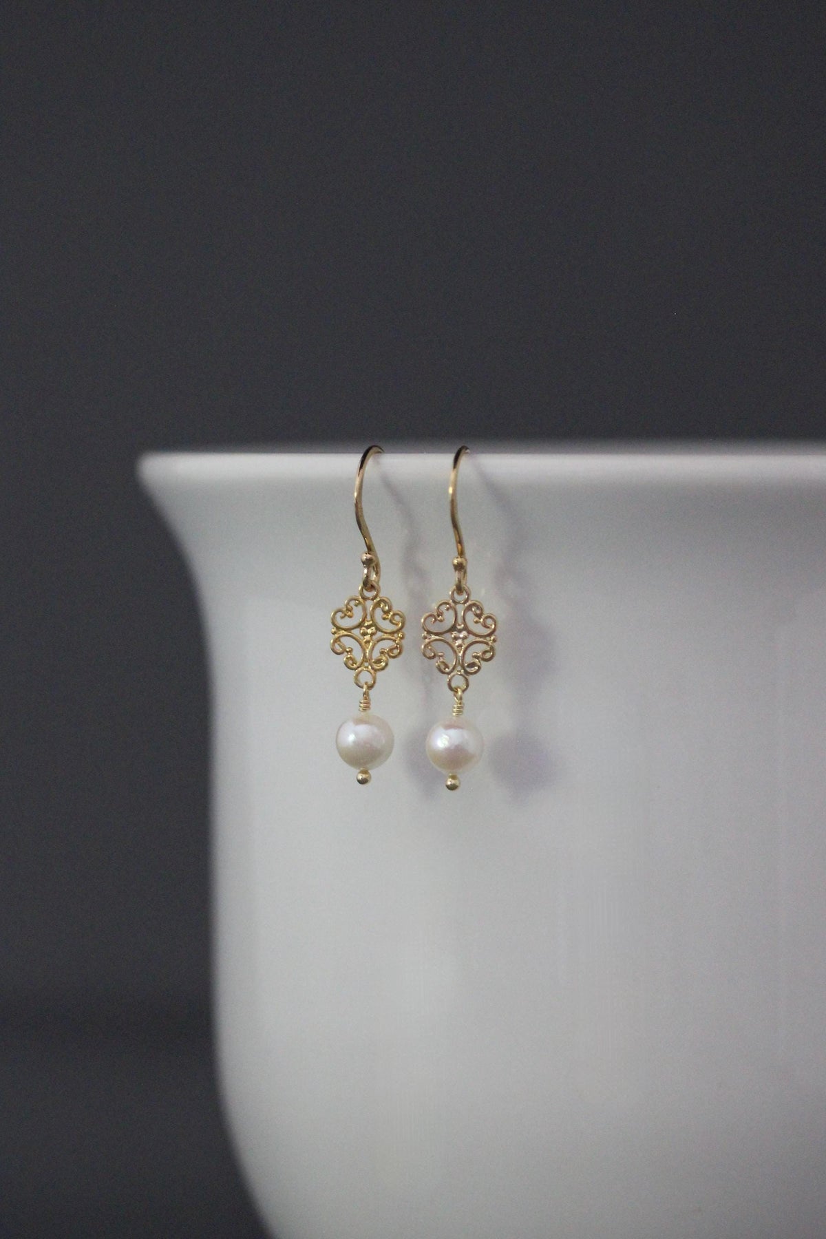 Gold vermeil pearl earrings with delicate scrollwork links and fishhook wires