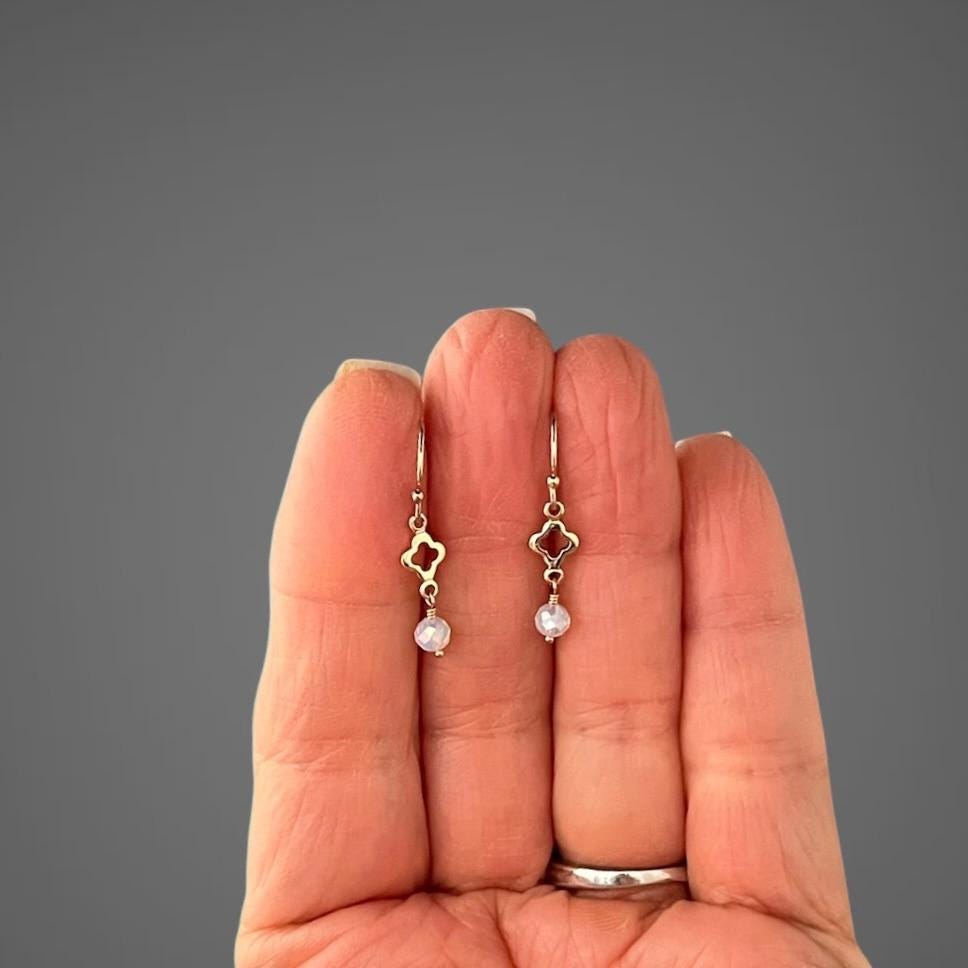 Petite gold-filled opalite earrings with clover links, shown for scale