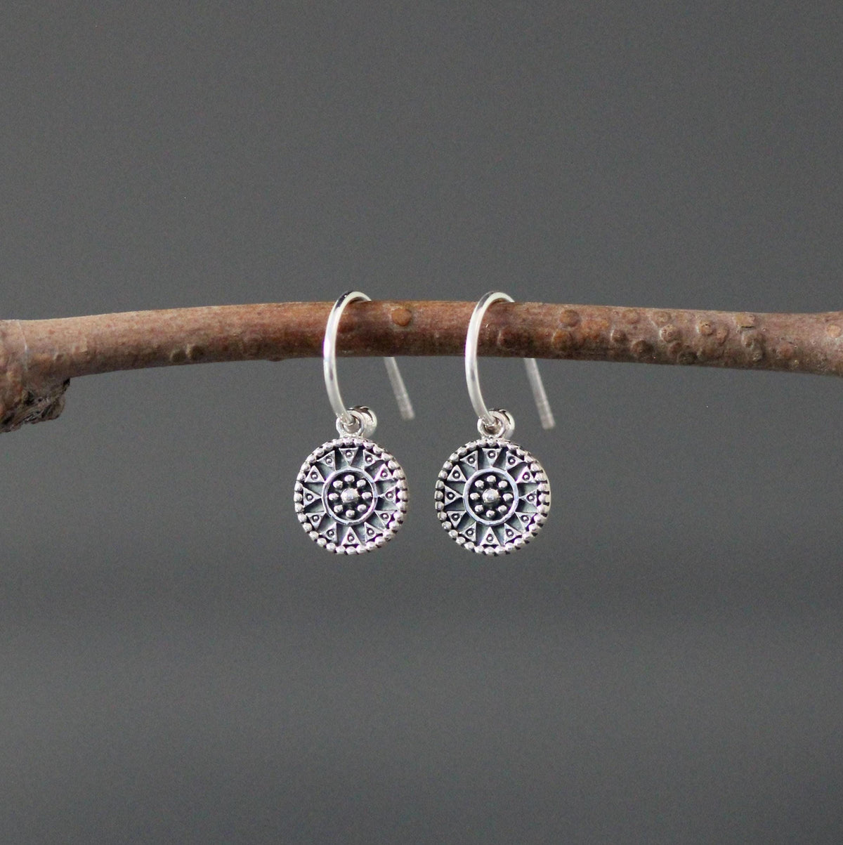 Sterling silver medallion charm earrings with fishhook wires and detailed circular designs
