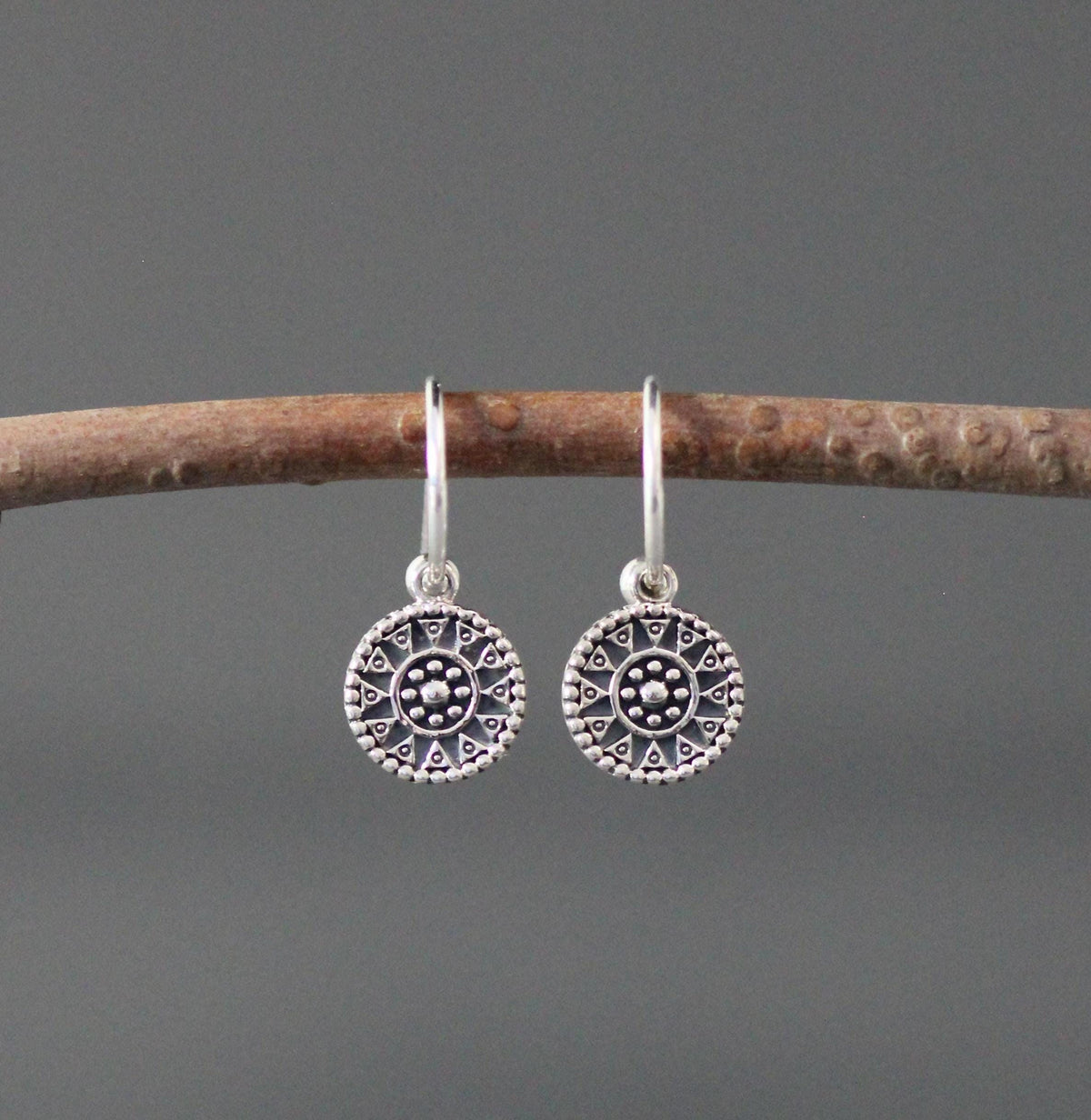 Sterling silver earrings with large round medallion charms and long fishhook wires