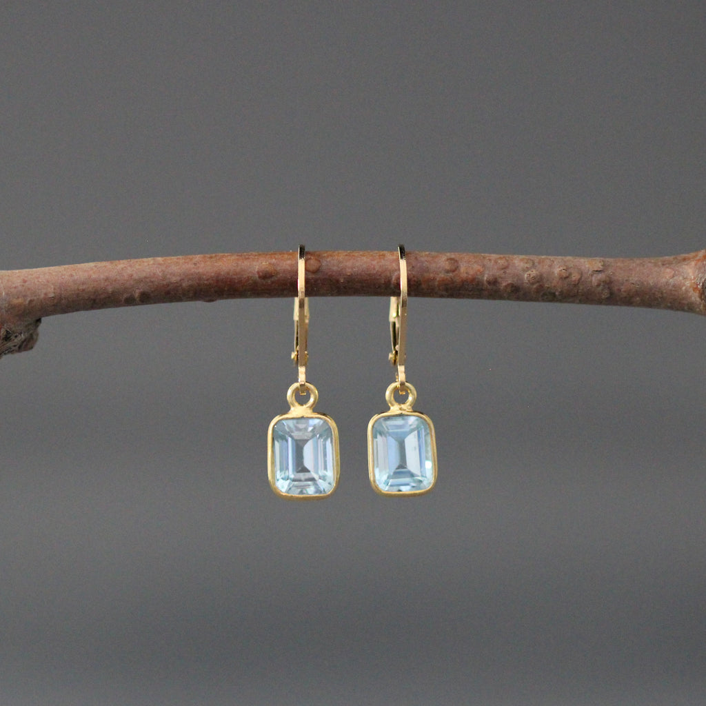 Gold vermeil leverback earrings with light blue emerald-cut stones in bezel settings