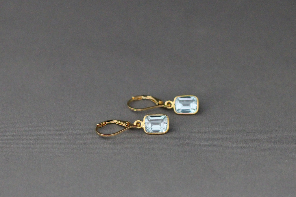 Gold vermeil leverback drop earrings with light blue emerald-cut bezel stones