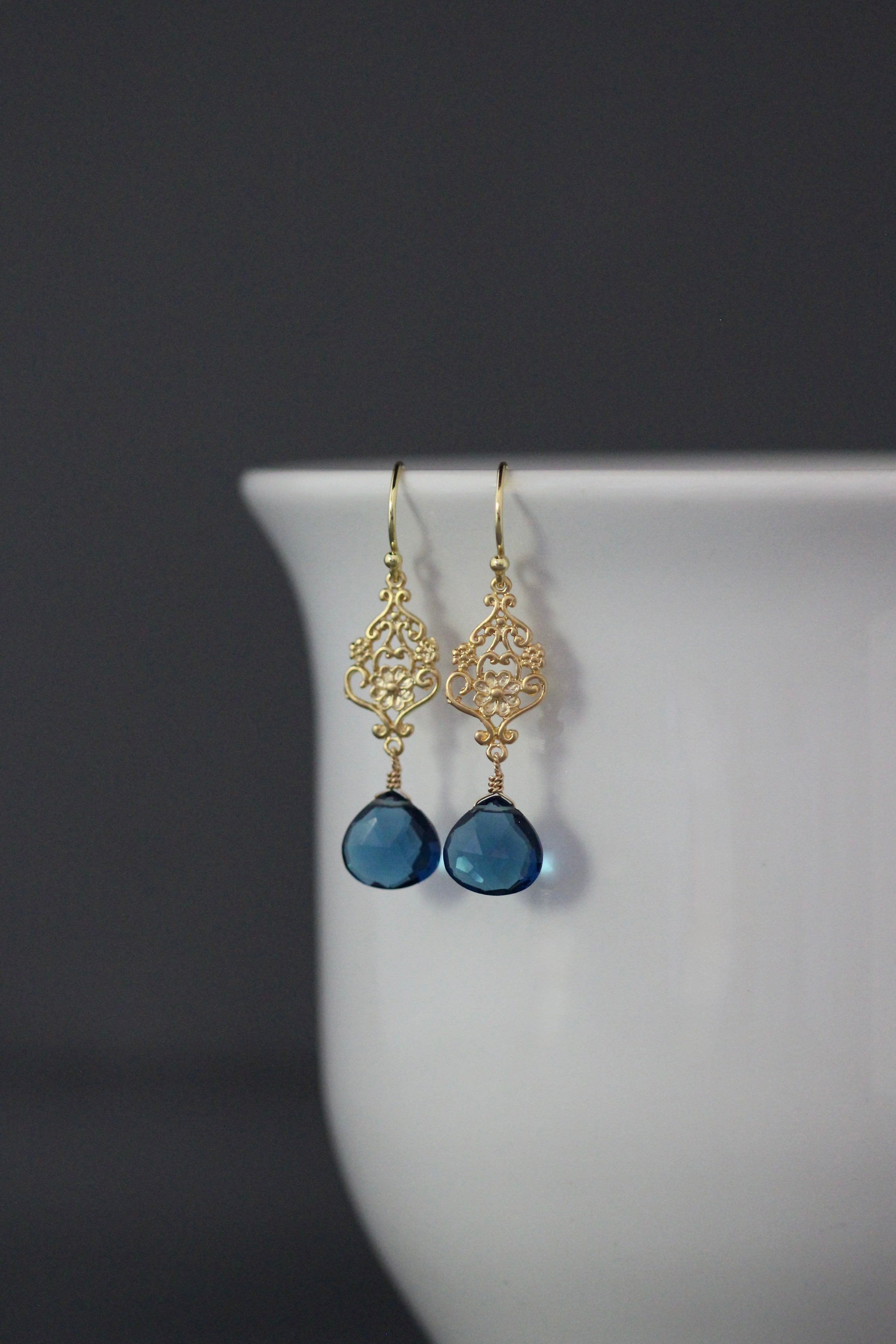 Gold vermeil filigree drop earrings with blue teardrop topaz stones