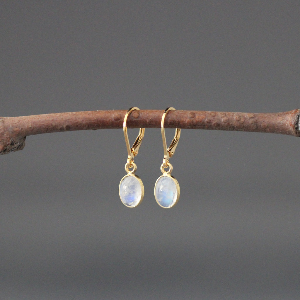 Gold leverback earrings with oval moonstone cabochons, gold bezel drops