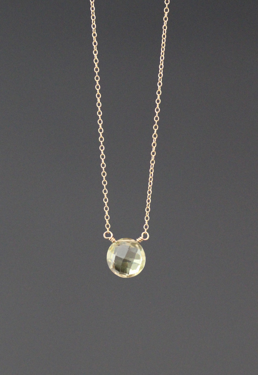 Gold necklace with wire-wrapped yellow quartz pendant on a fine chain