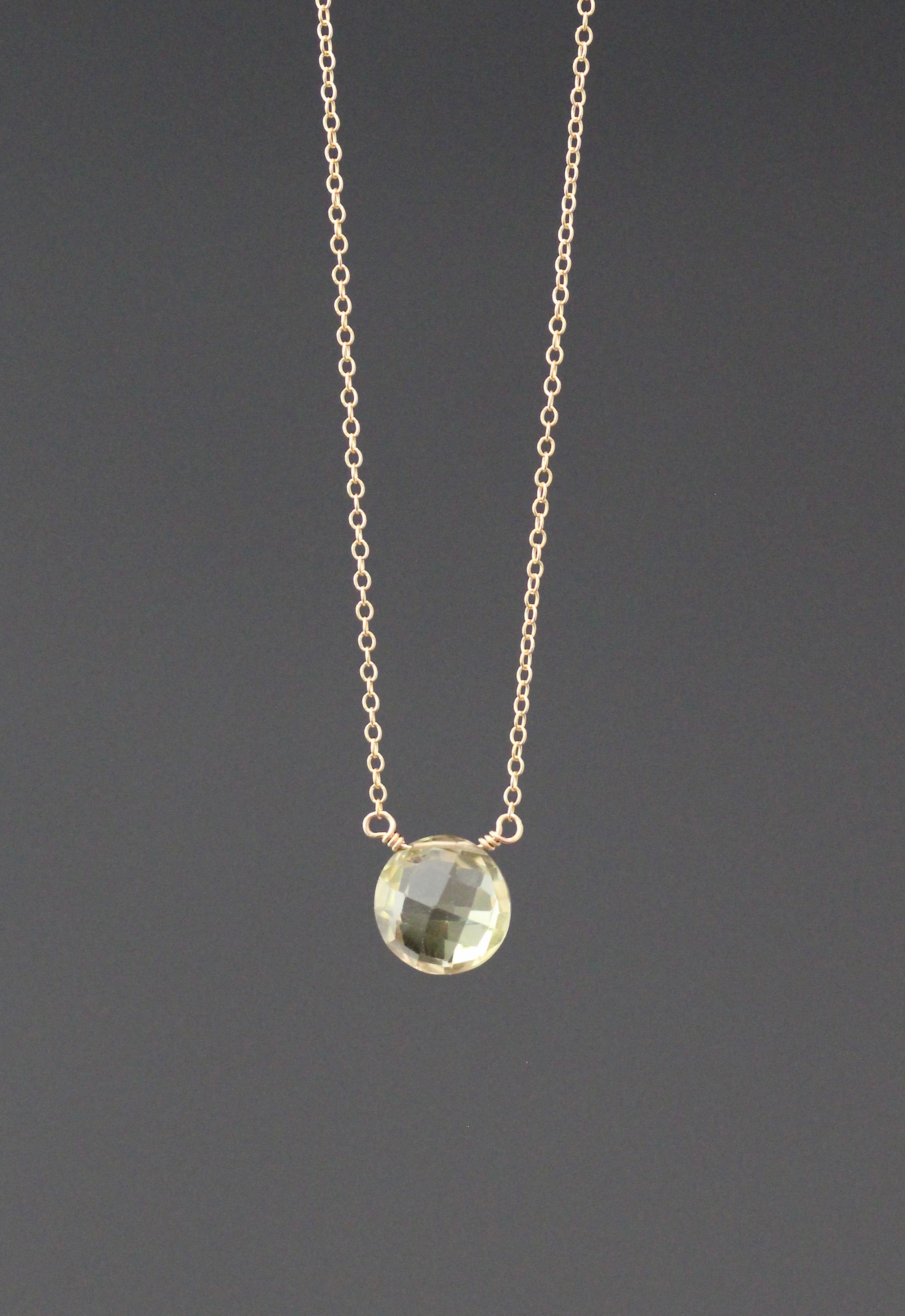 Gold necklace with wire-wrapped yellow quartz pendant on a fine chain
