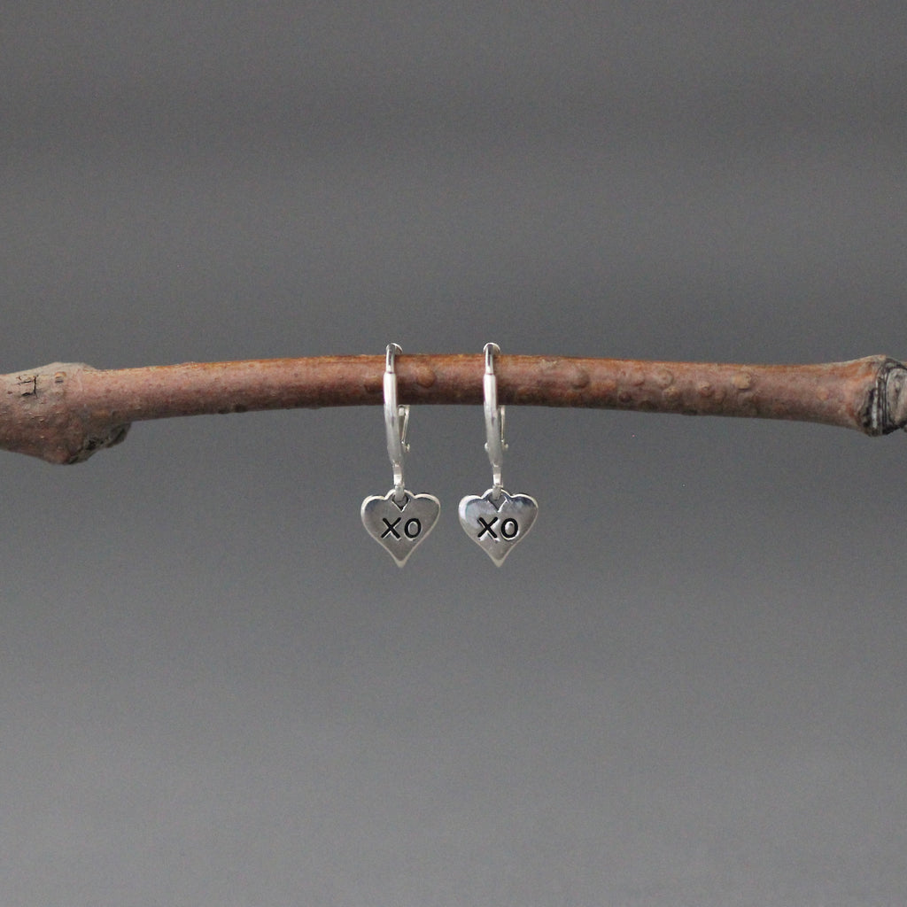 XO heart charm earrings on small silver huggie hoops with leverback closures