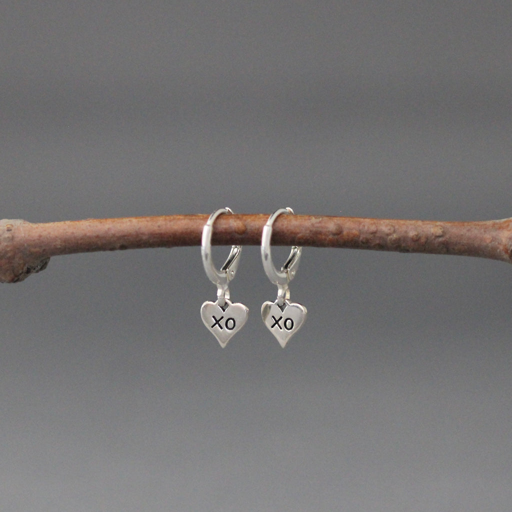 Sterling silver XO heart charm drop earrings on huggie hoops with leverbacks