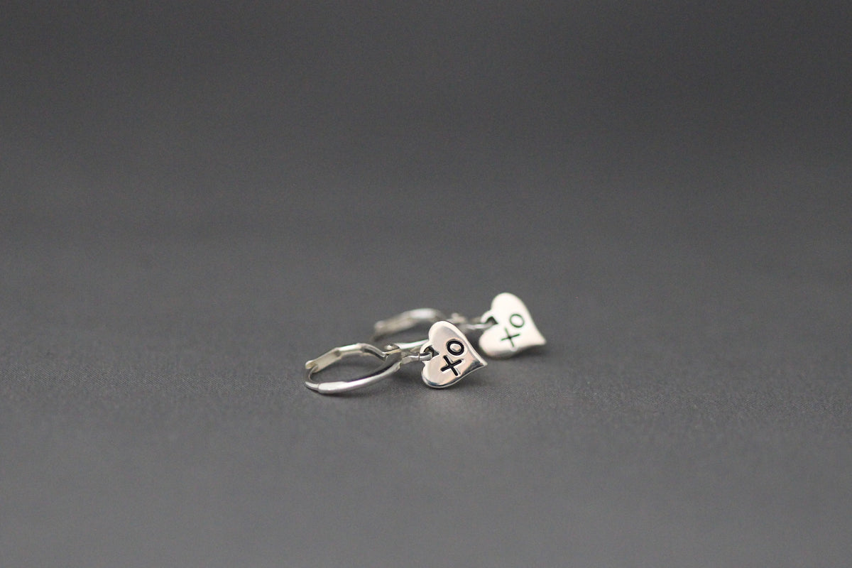 Silver leverback earrings with XO heart charms on small huggie hoops