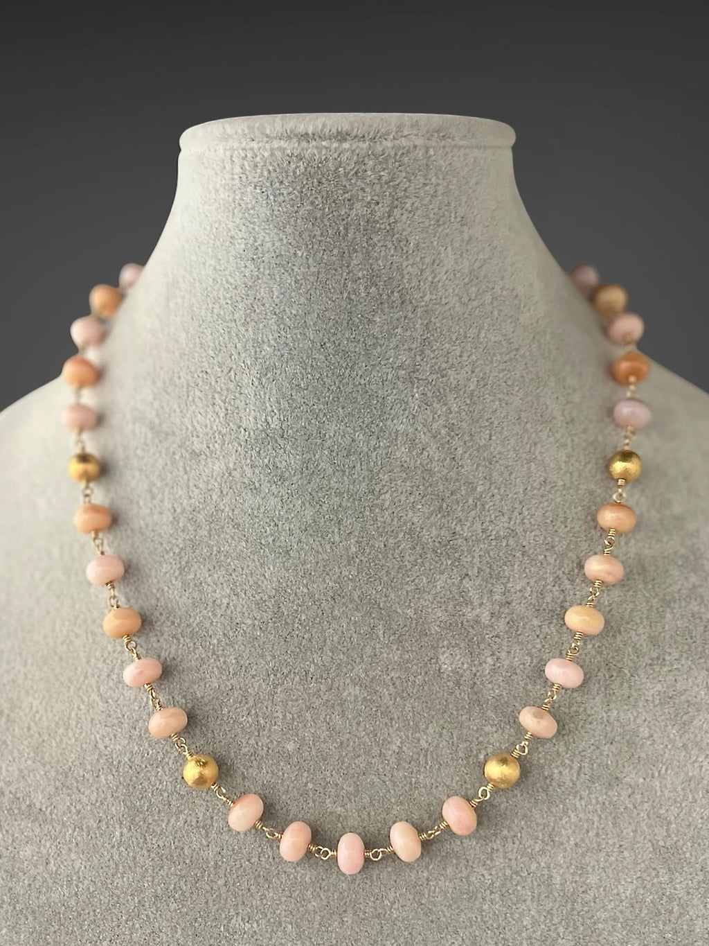 Beaded pink opal necklace with gold station accents and delicate chain clasp