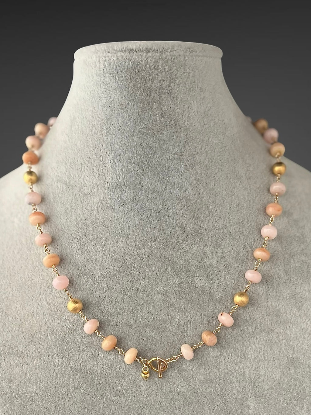 Gold filled beaded necklace with pink opal stations and small gold clasp charm