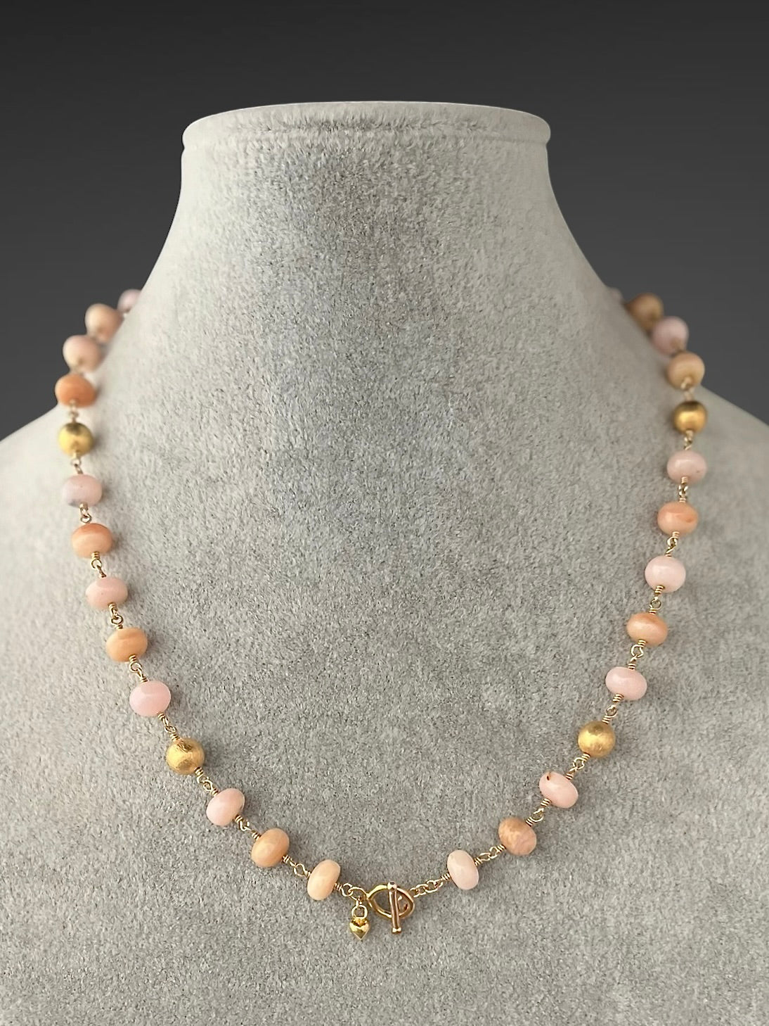 Gold filled beaded necklace with pink opal stations and small gold clasp charm