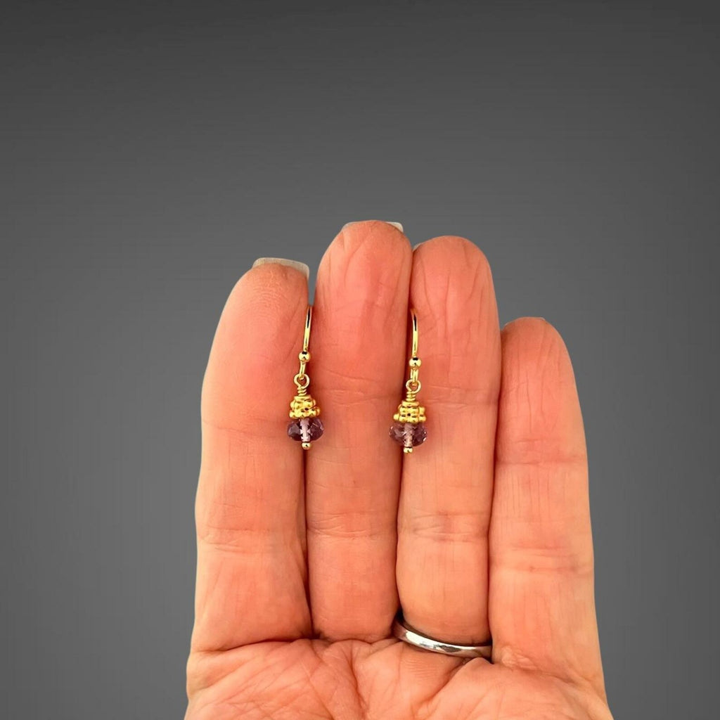 Purple amethyst button drop earrings shown on hand for size; gold-tone ear wires