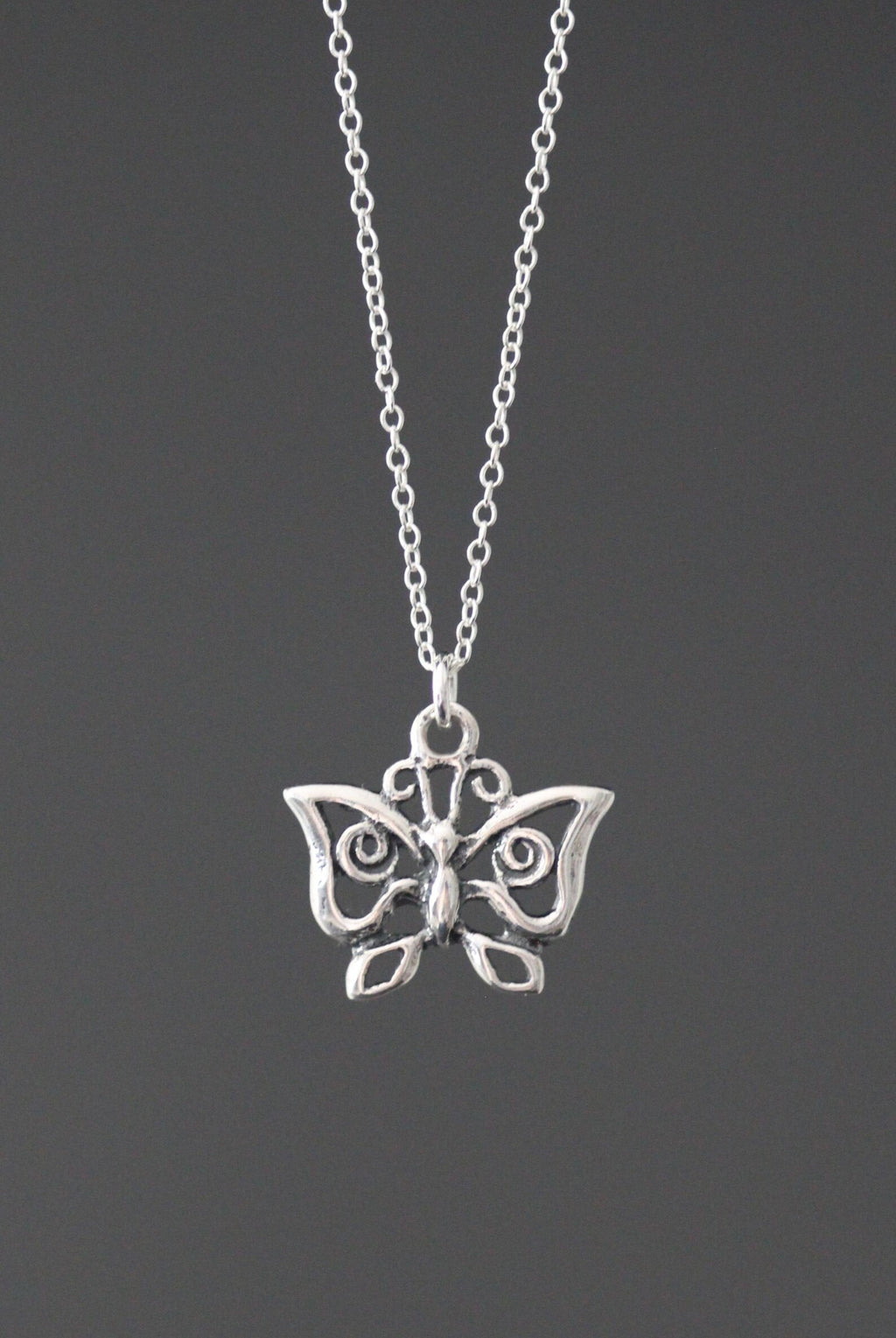 Sterling silver butterfly charm necklace with small winged pendant on link chain