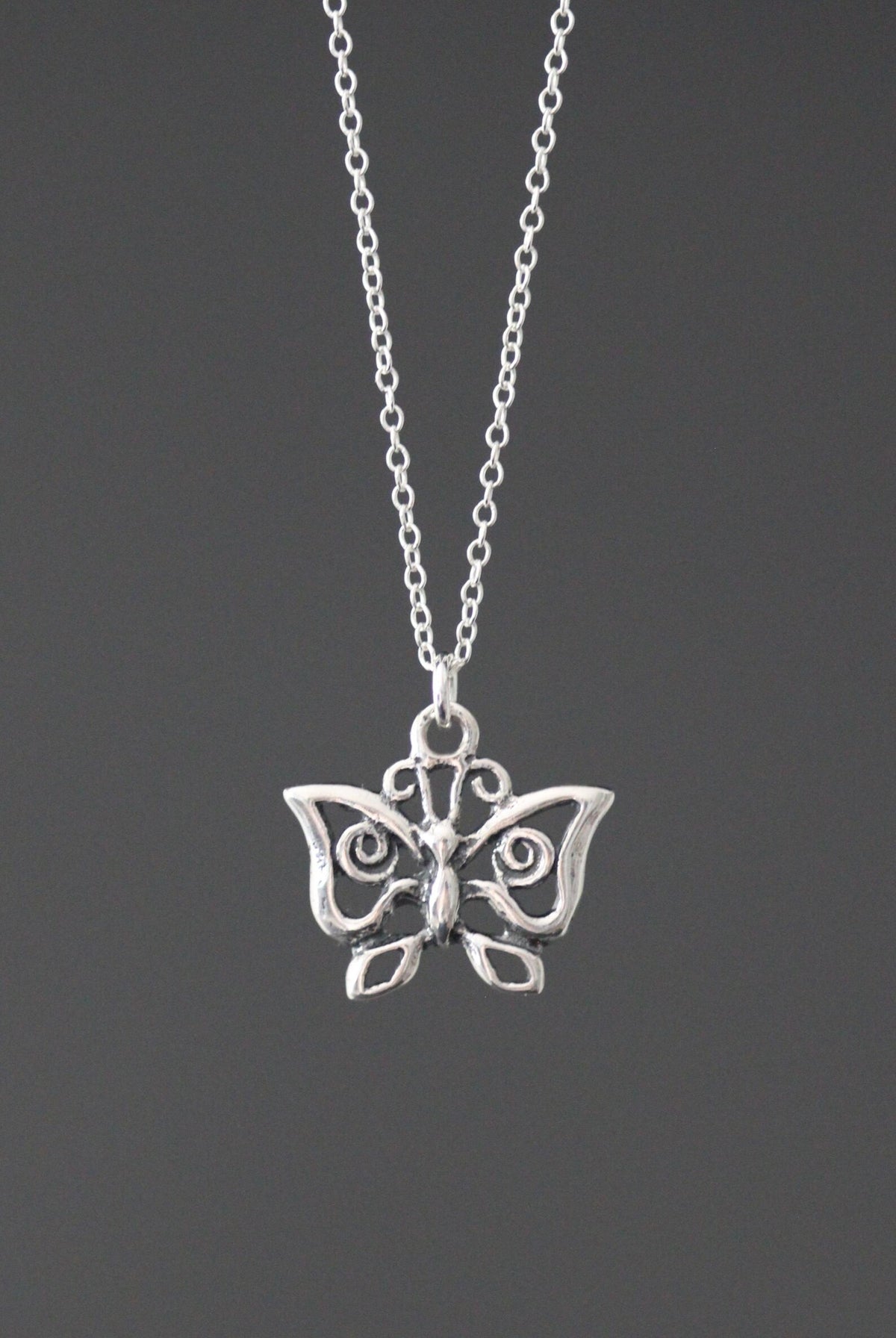 Sterling silver butterfly charm necklace with small winged pendant on link chain