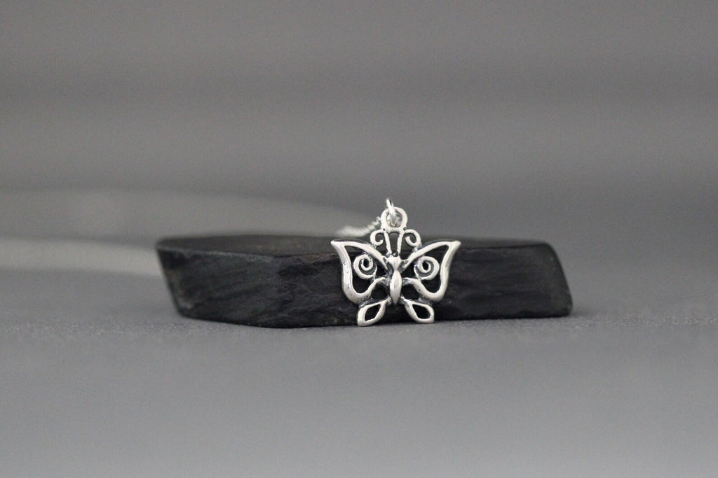Sterling silver butterfly charm pendant necklace on silver link chain, dangling center