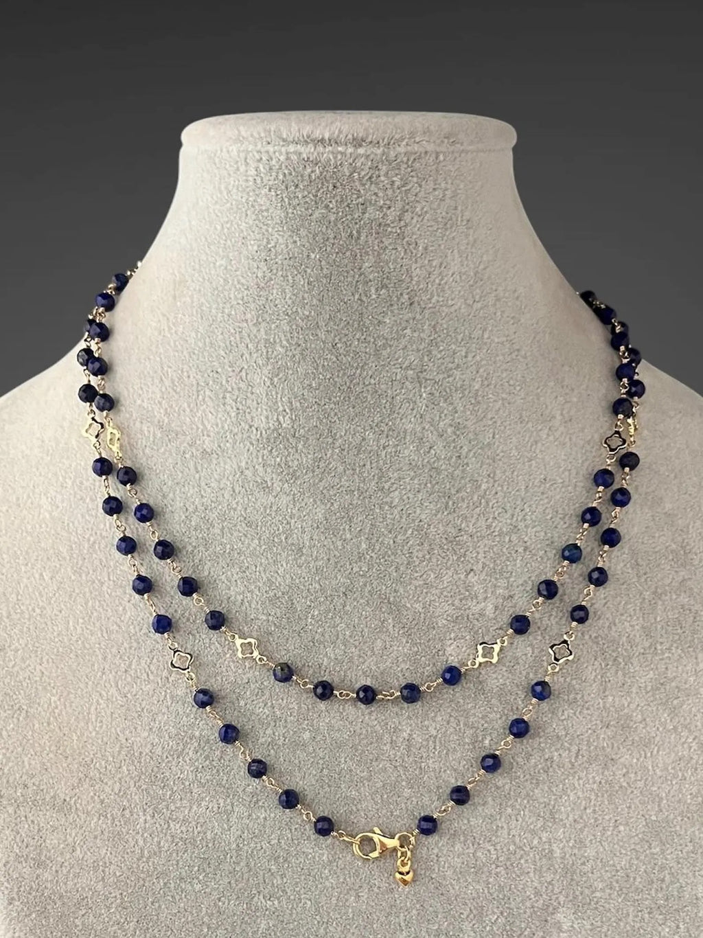 Three-strand blue lapis beaded necklace with gold connectors and small gold charm