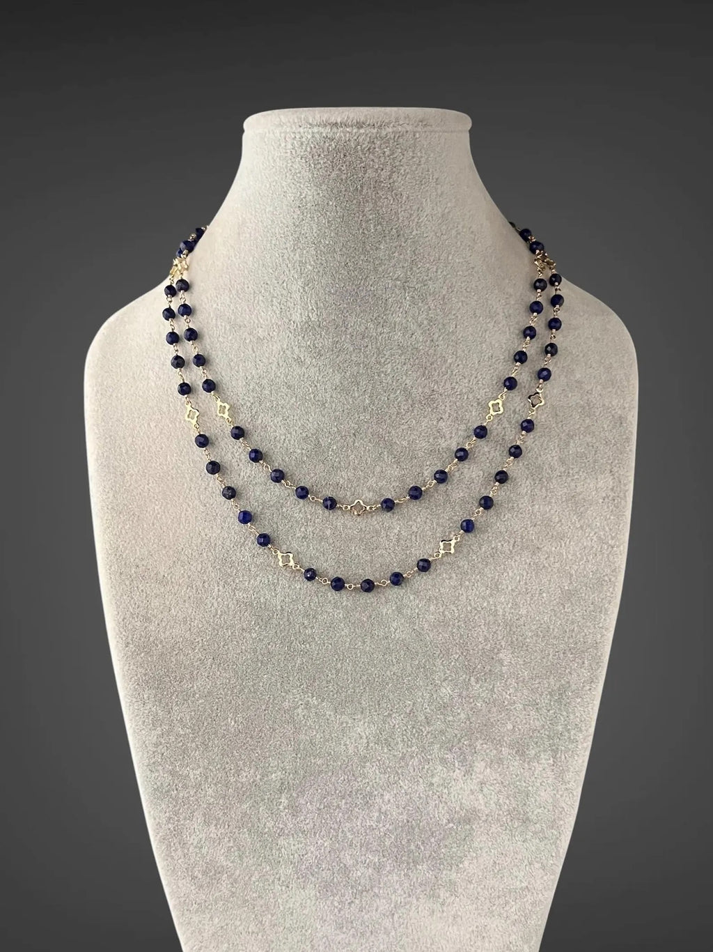 Multi-strand blue lapis beaded necklace with gold connectors and V-shaped center drop