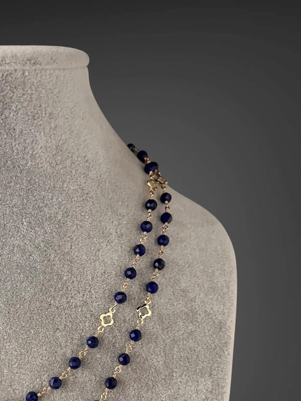 Blue lapis beaded necklace with gold wire-wrapped links and dangling bead detail