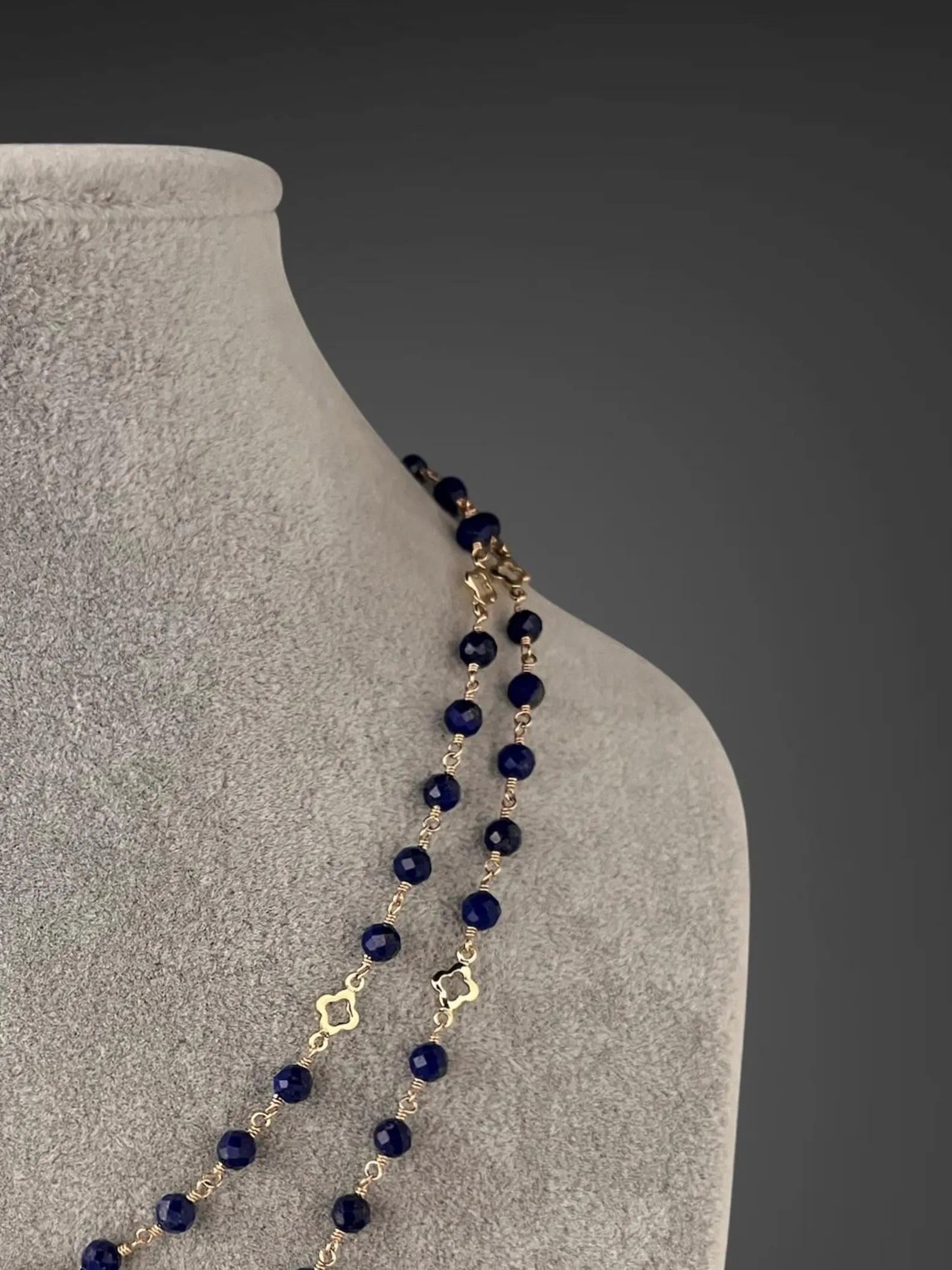 Blue lapis beaded necklace with gold wire-wrapped links and dangling bead detail
