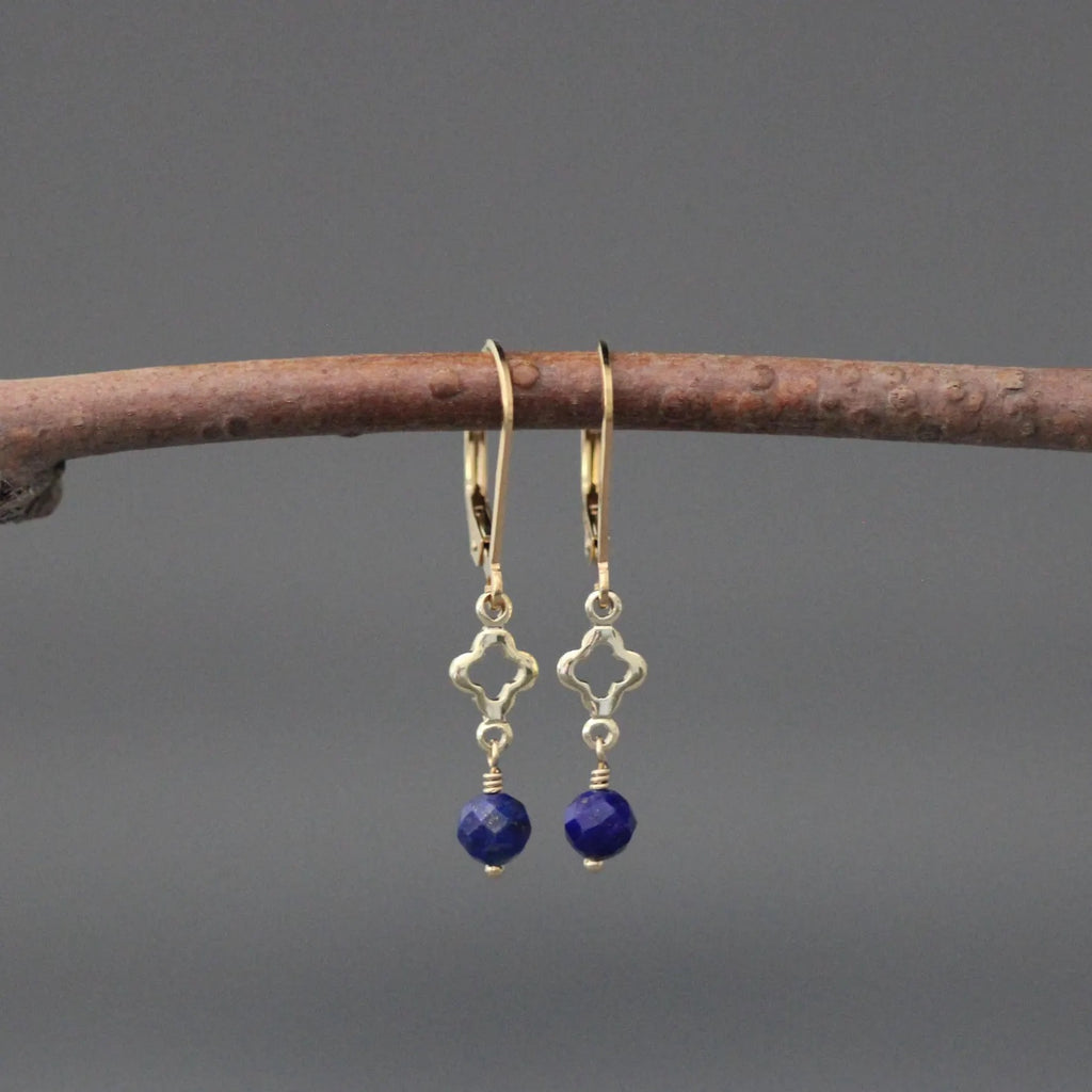 Gold hoop earrings with quatrefoil charm and blue lapis teardrop dangle
