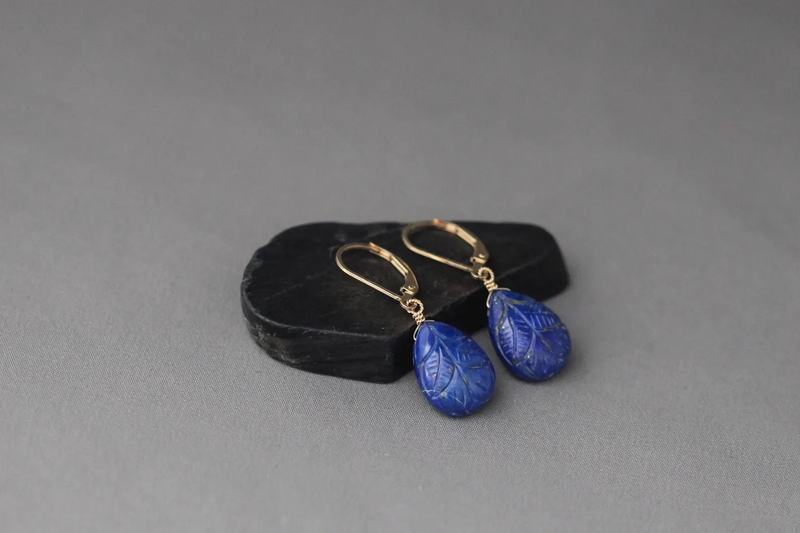 Gold leverback earrings with blue carved lapis leaf teardrop drops and hooks