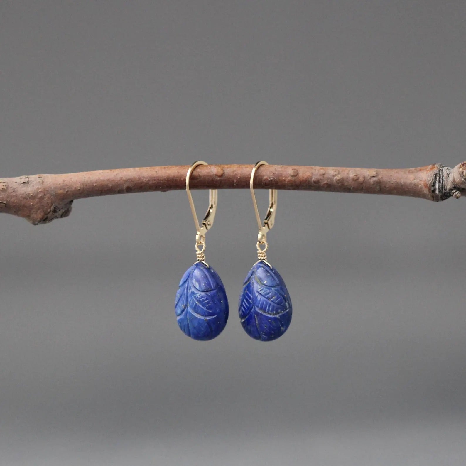 Carved blue lapis leaf teardrop earrings with gold leverback hooks