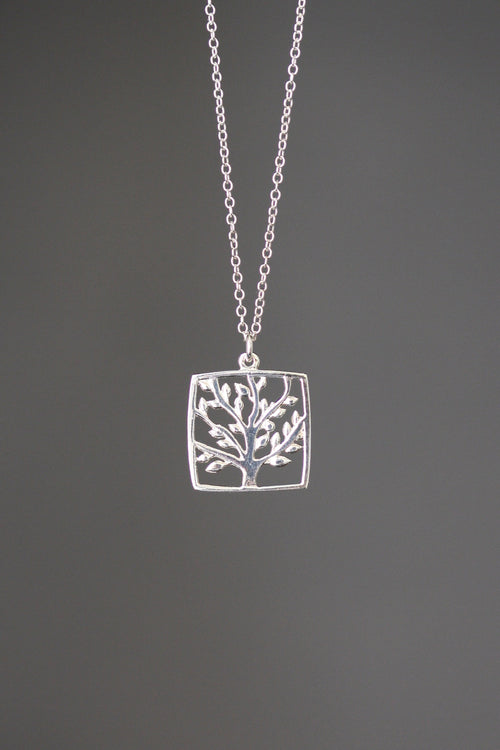Silver square charm necklace with tree-of-life engraving on a fine link chain