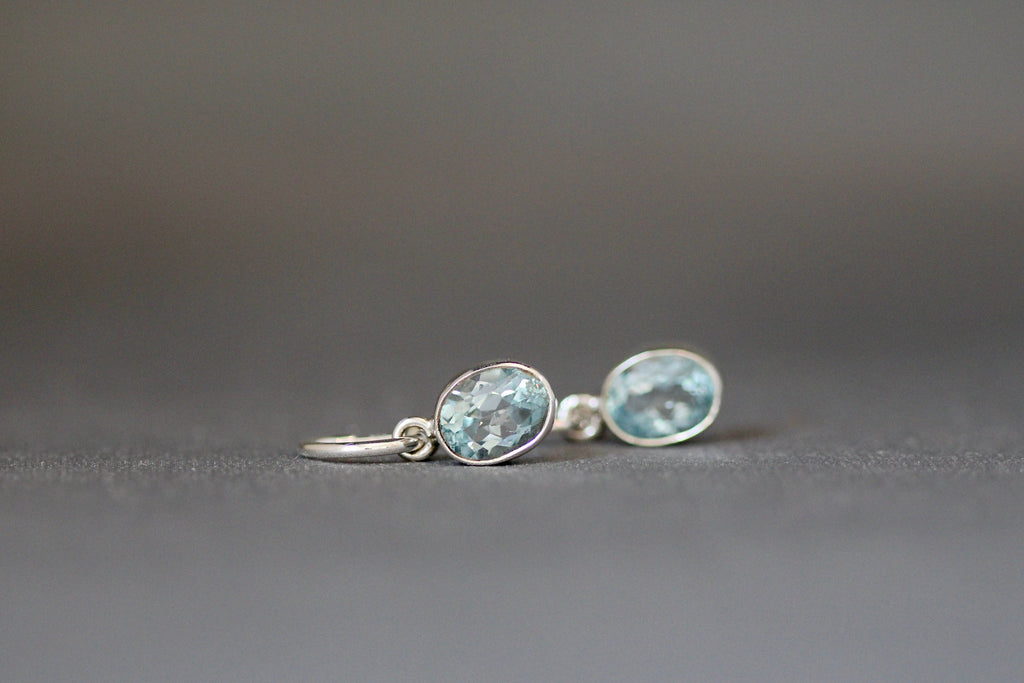 Blue Topaz Bezel Earrings Dangling from Sterling Silver Post Hoops