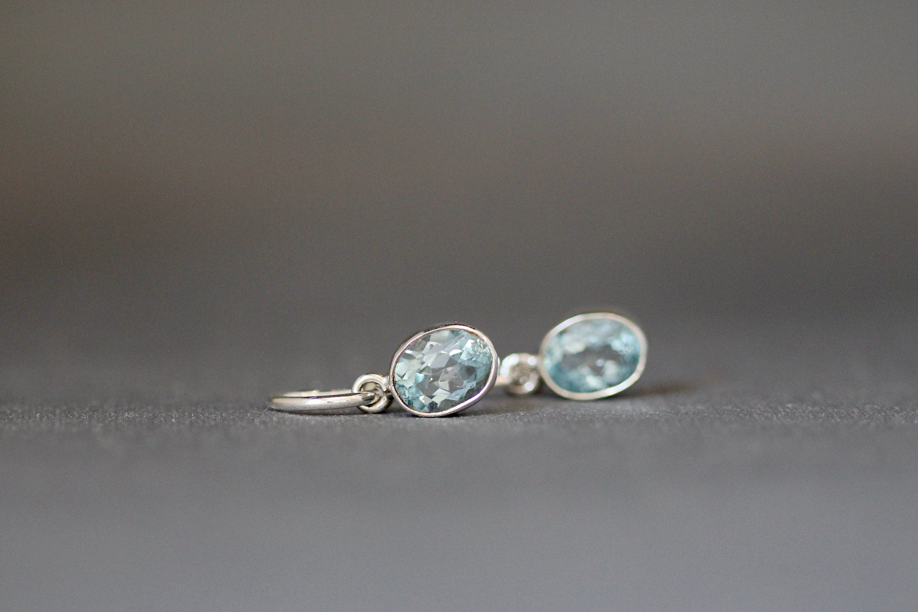 Blue Topaz Bezel Earrings Dangling from Sterling Silver Post Hoops
